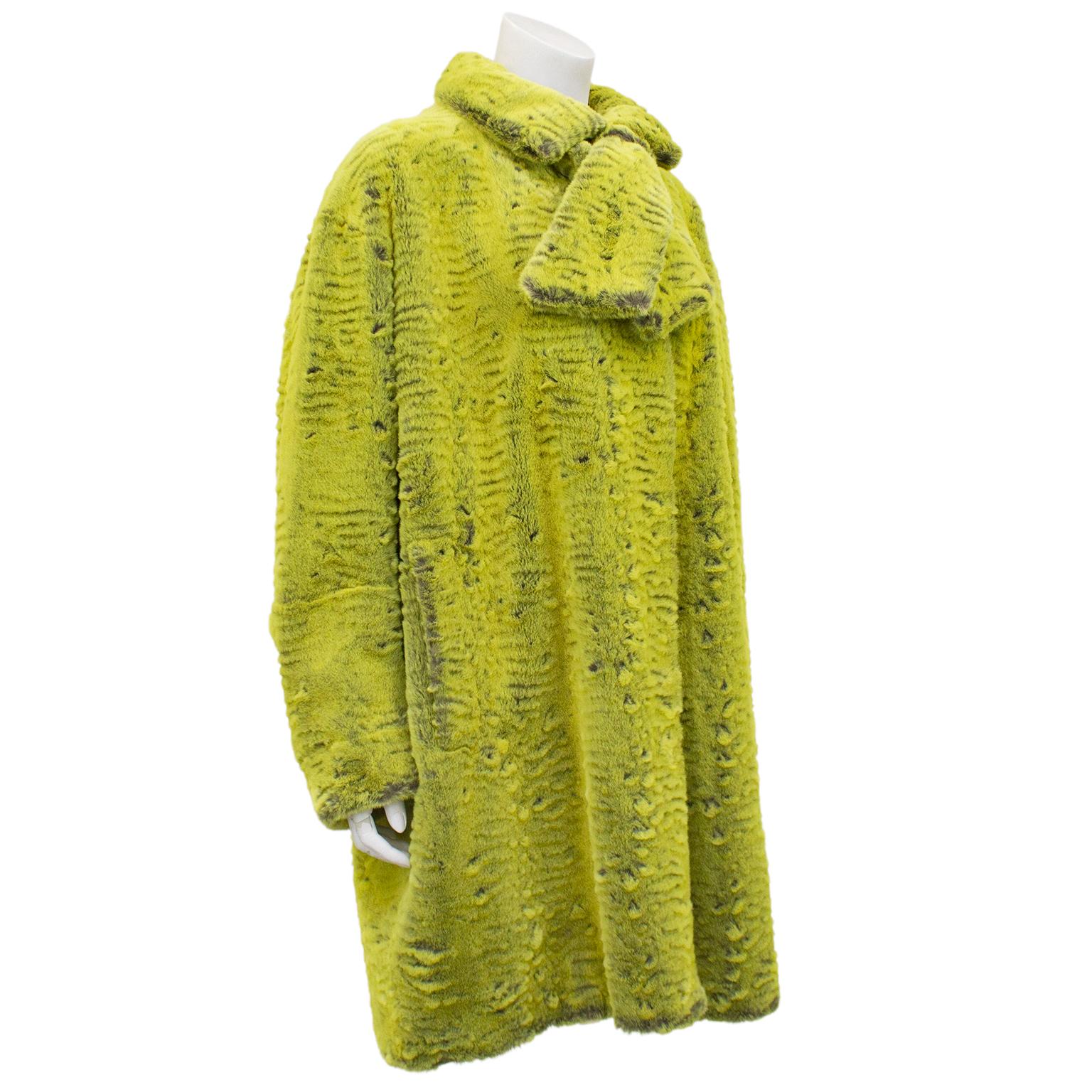 1990s gorgeous chartreuse faux fur coat by Christian Lacroix. Swing style with short scarf that is attached to the collar. Hidden buttons up centre front and vertical slit pockets. Black lining contrasts against the iconic hot pink Lacroix label.