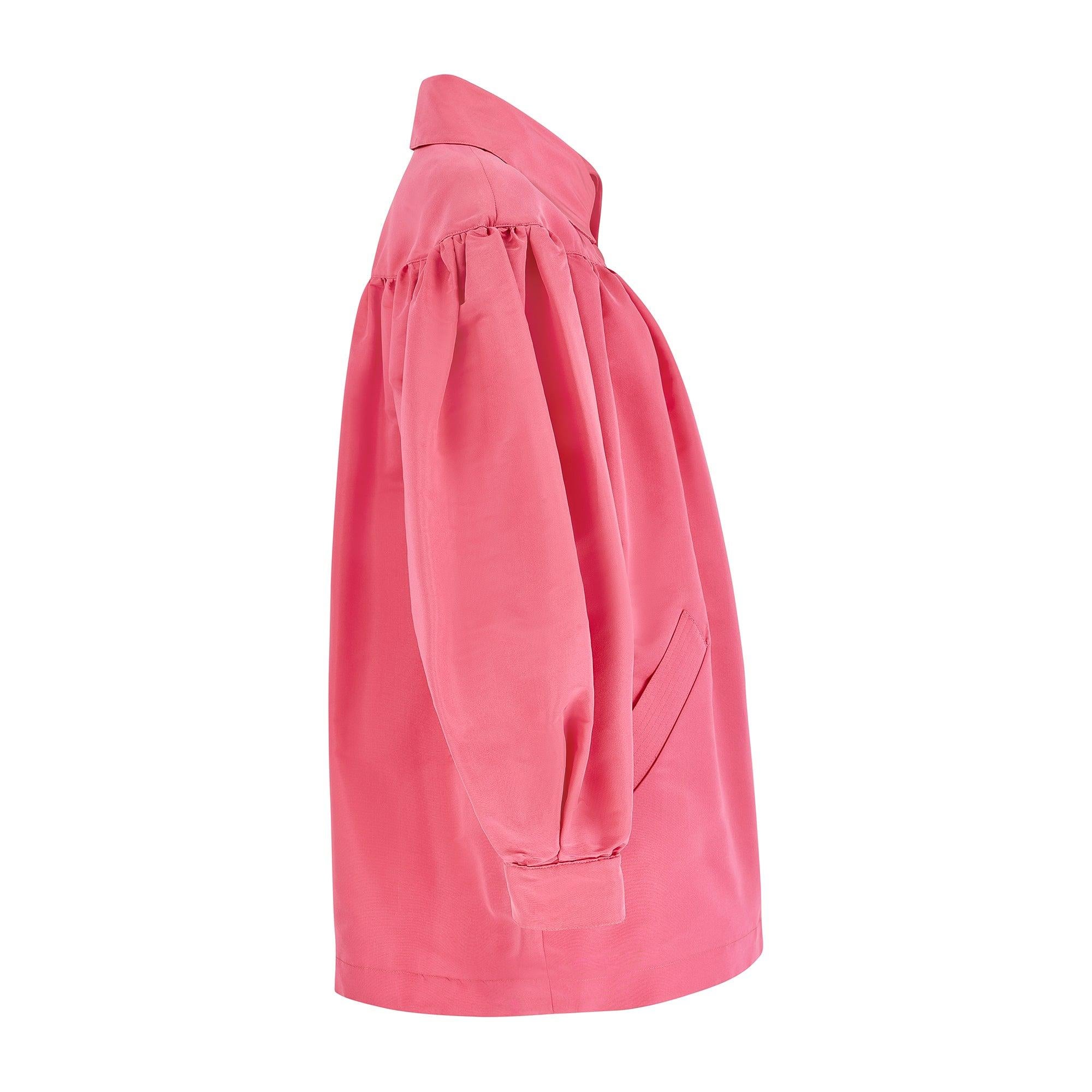 Questa voluminosa giacca rosa allungata è un modello tipicamente vivace del couturier francese Christian Lacroix. Presenta l'etichetta rosa 