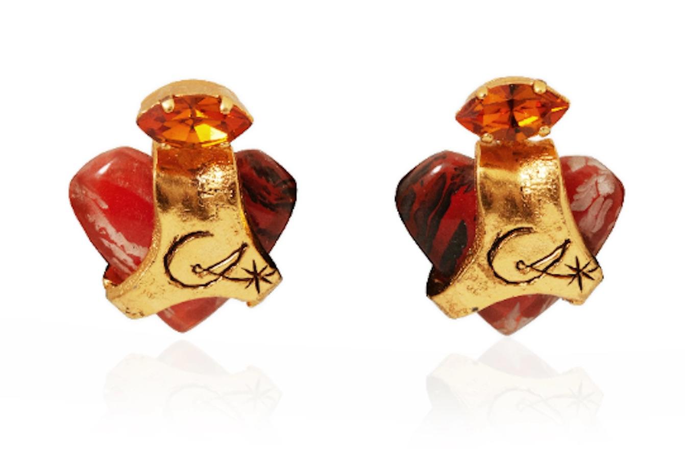 1990s Christian Lacroix abstract heart earrings made from an orange painted resin which has then been partially 'wrapped' in a textured gold plated overlay engraved with the maker’s initials, 'CL' topped with a little Marcasite shaped faux topaz