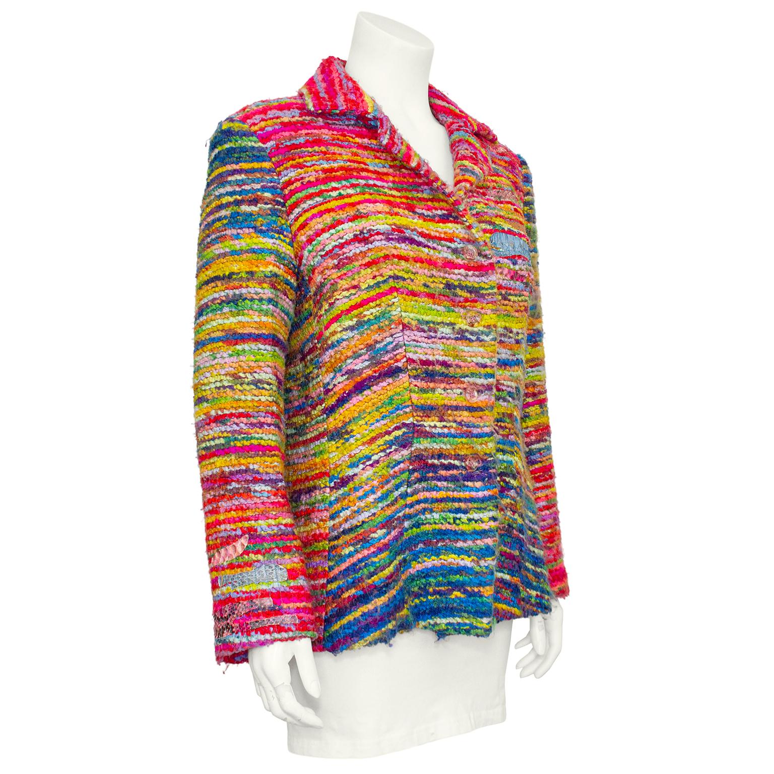 Christian Lacroix jacket from the 1990s. Bright multi-color variegated boucle with patches of bright colored faux reptile skin at the left shoulder and right cuff. Patches are further embellished with blue vertical top stitching. Round clear plastic