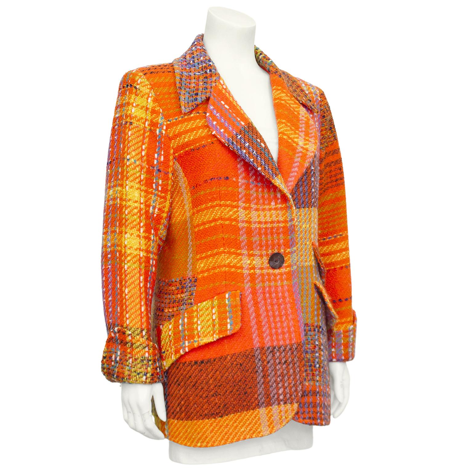 Christian Lacroix equestrian style blazer from the 1990s. Patchwork orange, yellow and purple tweed with a distorted plaid pattern throughout. Notched collar and single carved wood button. Three flap pockets, two on the left and one on the right.
