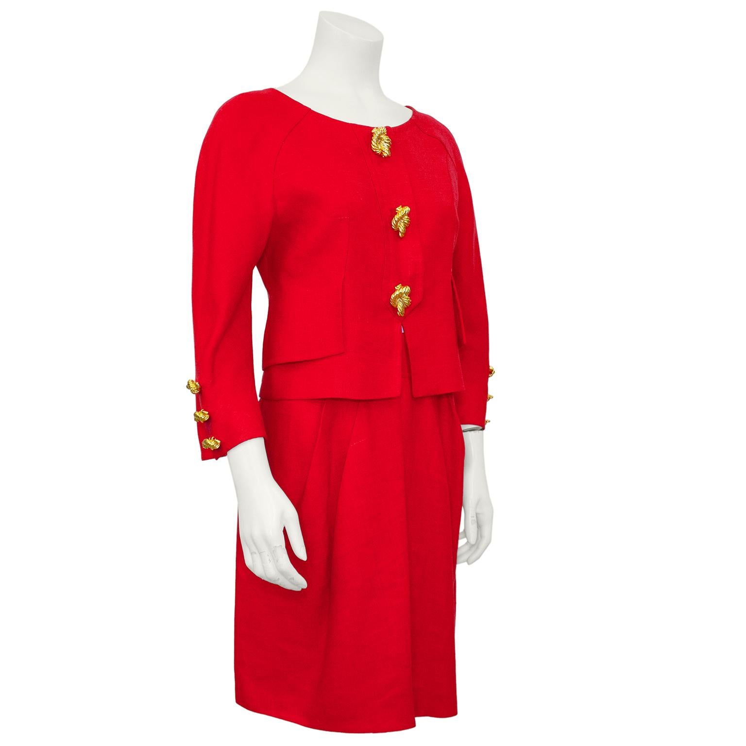 Vibrant raspberry red linen Christian Lacroix skirt suit form the 1990s. Collarless boat neck jacket with beautiful seam work and oversized pocket flaps. Embellished with some of the most fabulous buttons that we have every seen! Very heavy gold