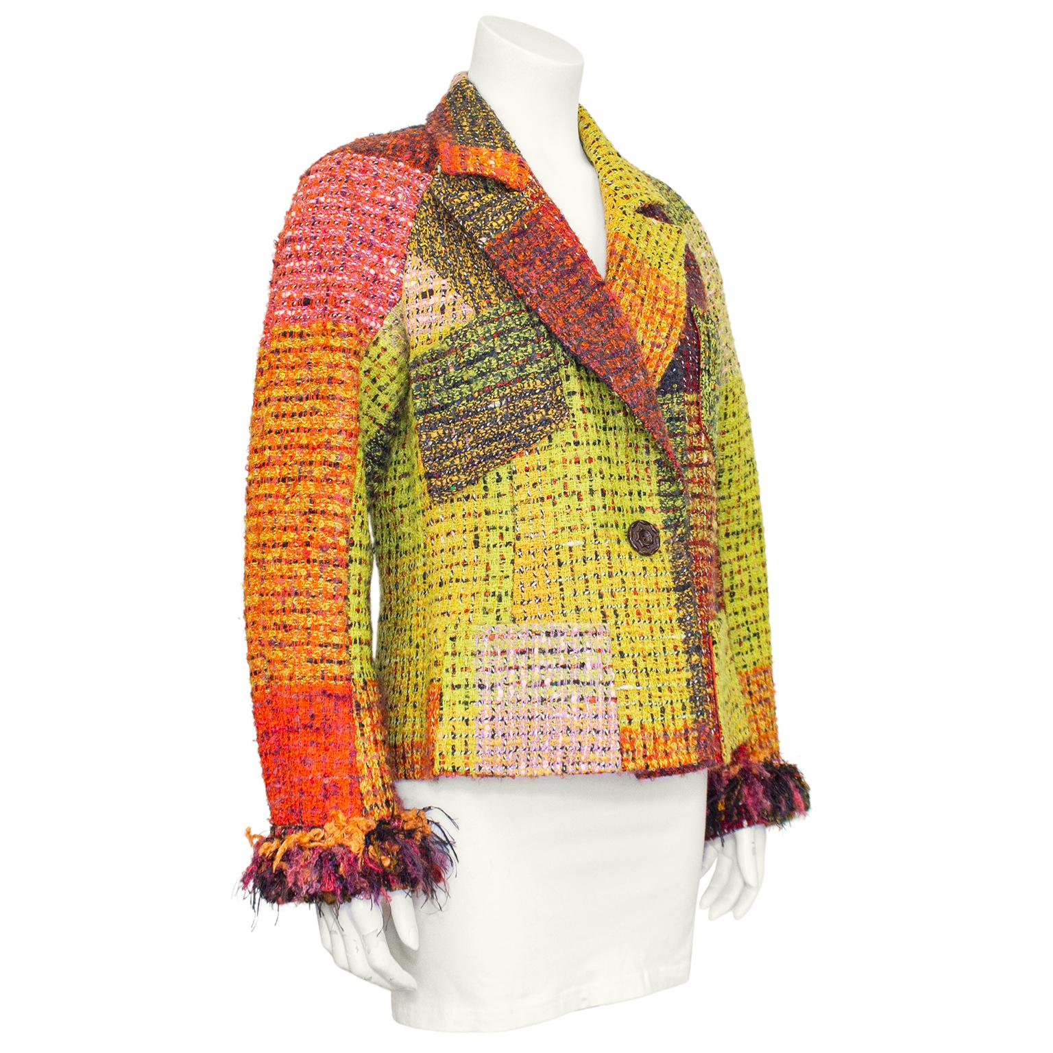 1990s Christian Lacroix tweed blazer. Autumnal colour scheme with a mix of oranges, browns purples and lime greens. Fringe and looped yarn cuffs and single large dark brown wood button. Orange and yellow silk lining. Excellent vintage condition.