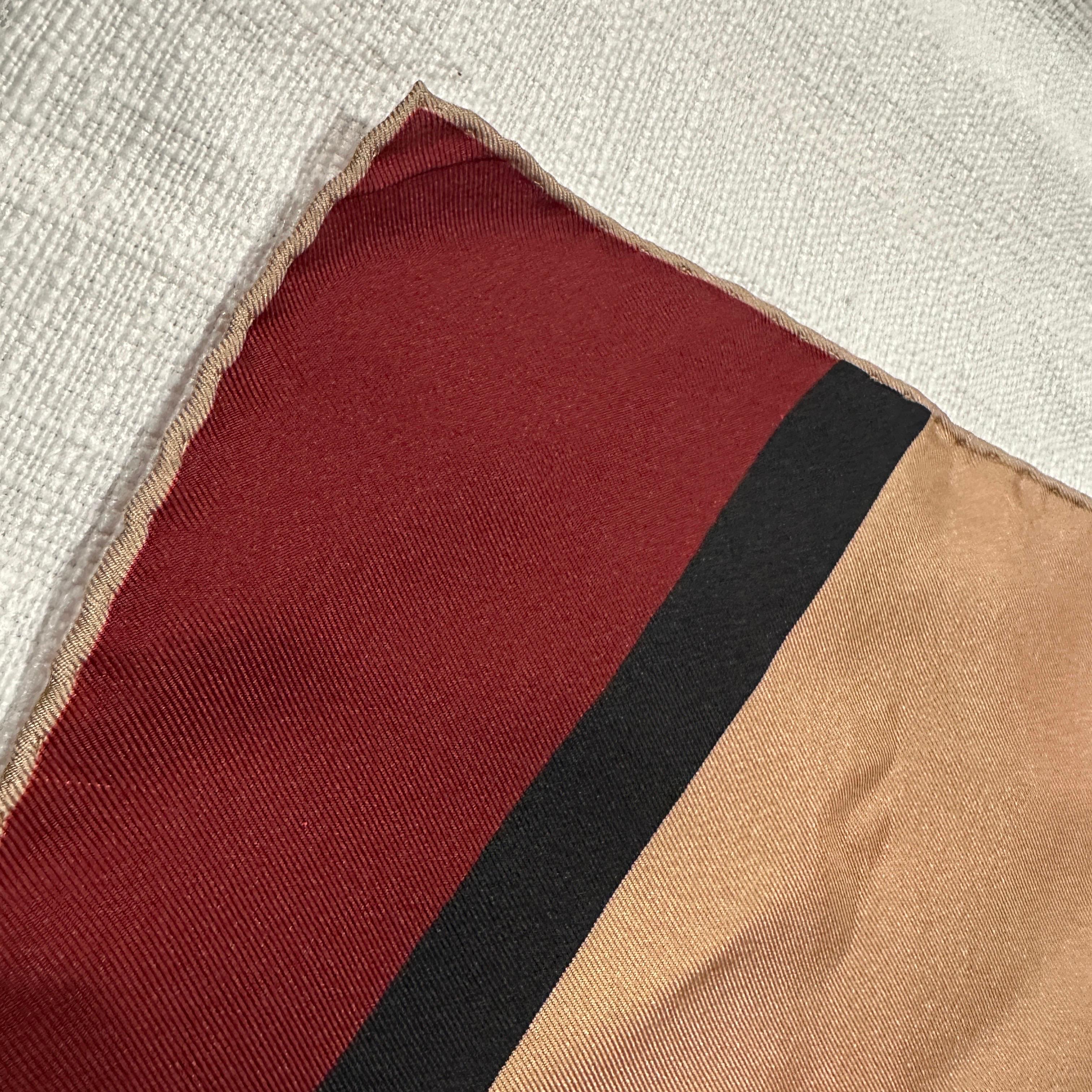 This is a beautiful, classic Valentino silk scarf dating from the 1990s, a period when the brand, under founder Valentino Garavani, was celebrated for its dramatic flair and luxurious materials. Crafted in 100% fine silk, this piece showcases the