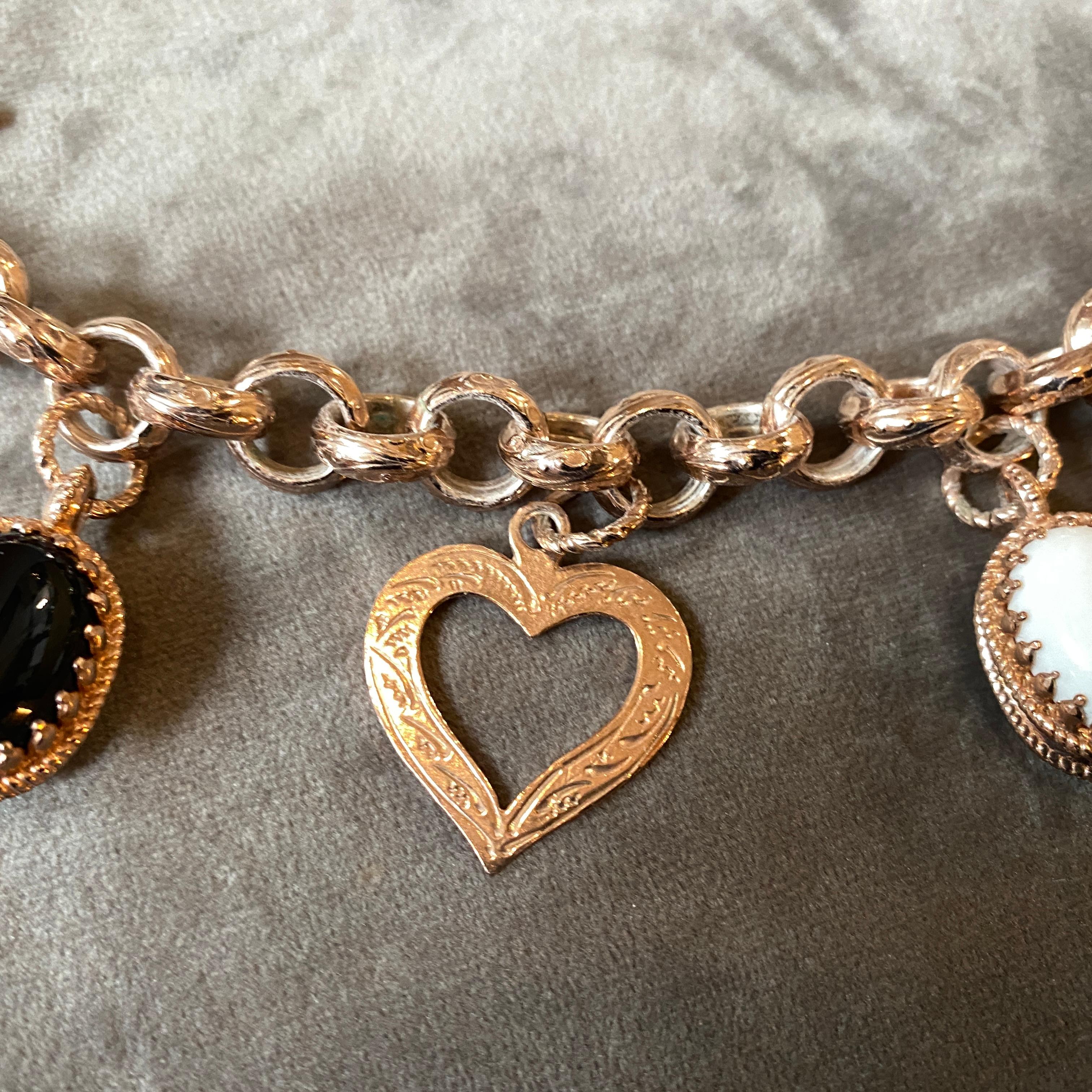 An hand-crafted charm bracelet made in Italy in the Nineties by Anomis, it's in lovely condition, the onyx and white agate cabochon and the gold plated sterling silver gives it a real jewel look. The hearts are mixed with double sides onyx and agate
