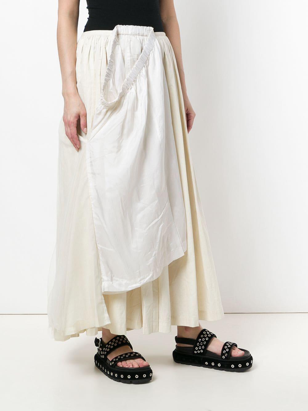 Comme des Garçons white and ivory white cotton blend layered mid rise maxi skirt, with a tubular designed waistband, a concealed metal hooks fastening, lightly pleated design and a fake white petticoat appliqué to the front. 

Years: 90s

Size: