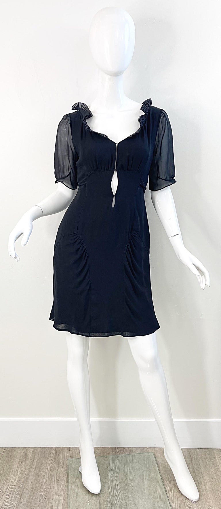 Late 90s COSTUME NATIONAL black silk chiffon short sleeve cut-out babydoll style dress ! Features multiple layers of soft silk chiffon. Ties in the back. Two hook-and-eye closures at bust. Ruffles around the neck. The perfect timeless little black