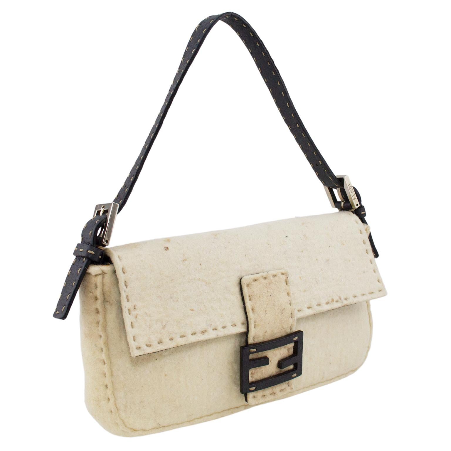 1990s Fendi cream felted wool baguette. Oatmeal coloured top stitching, dark brown leather strap with matching oatmeal top stitching and silver buckles and brown leather interlocking Fendi F logo at closure. Beige suede interior with single zippered
