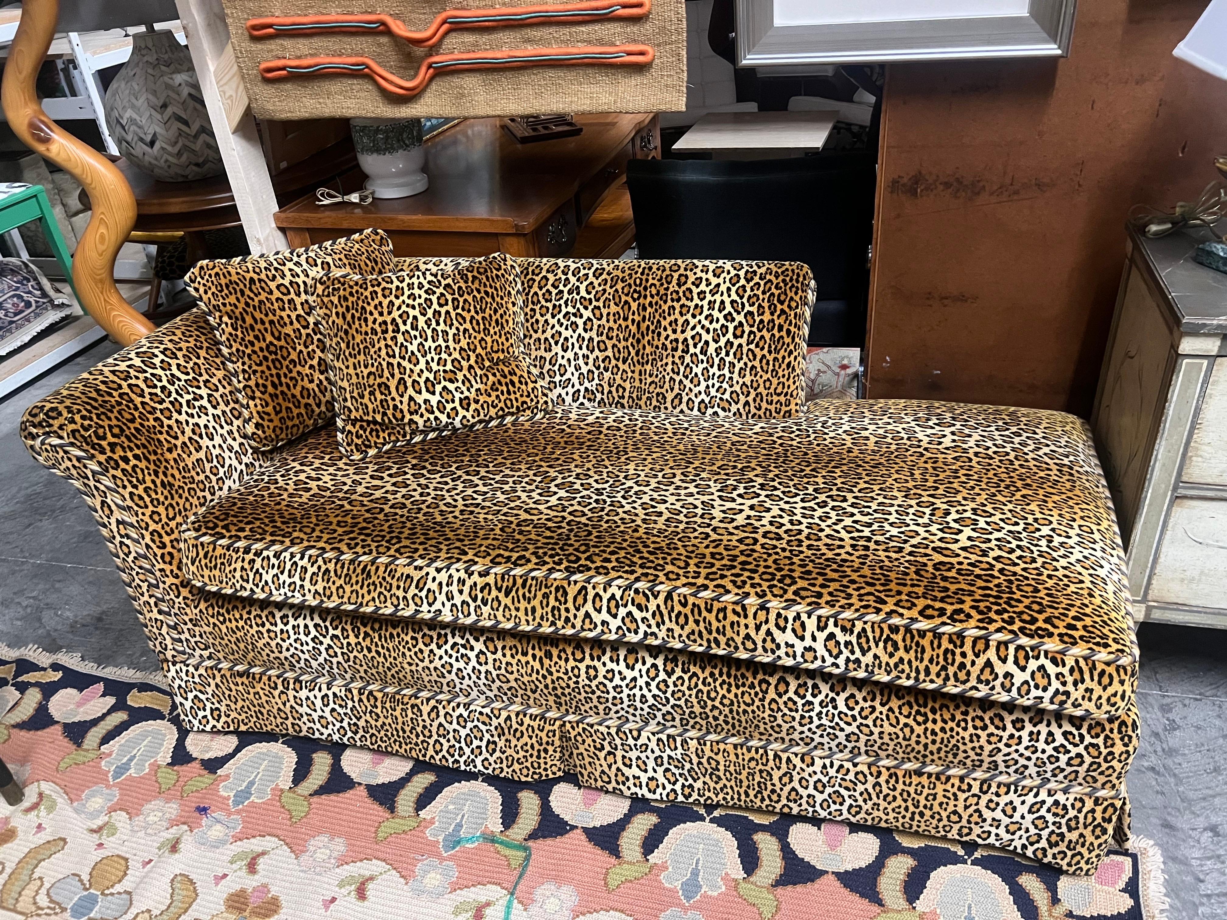 A custom velveteen cheetah upholstered chaise lounge with a rolled back and arm.  Piping is in braided cheetah colors.   Also comes with 2 matching pillows.   One of a kind and very well made.  Acquired from a South Battery estate in charleston sc.