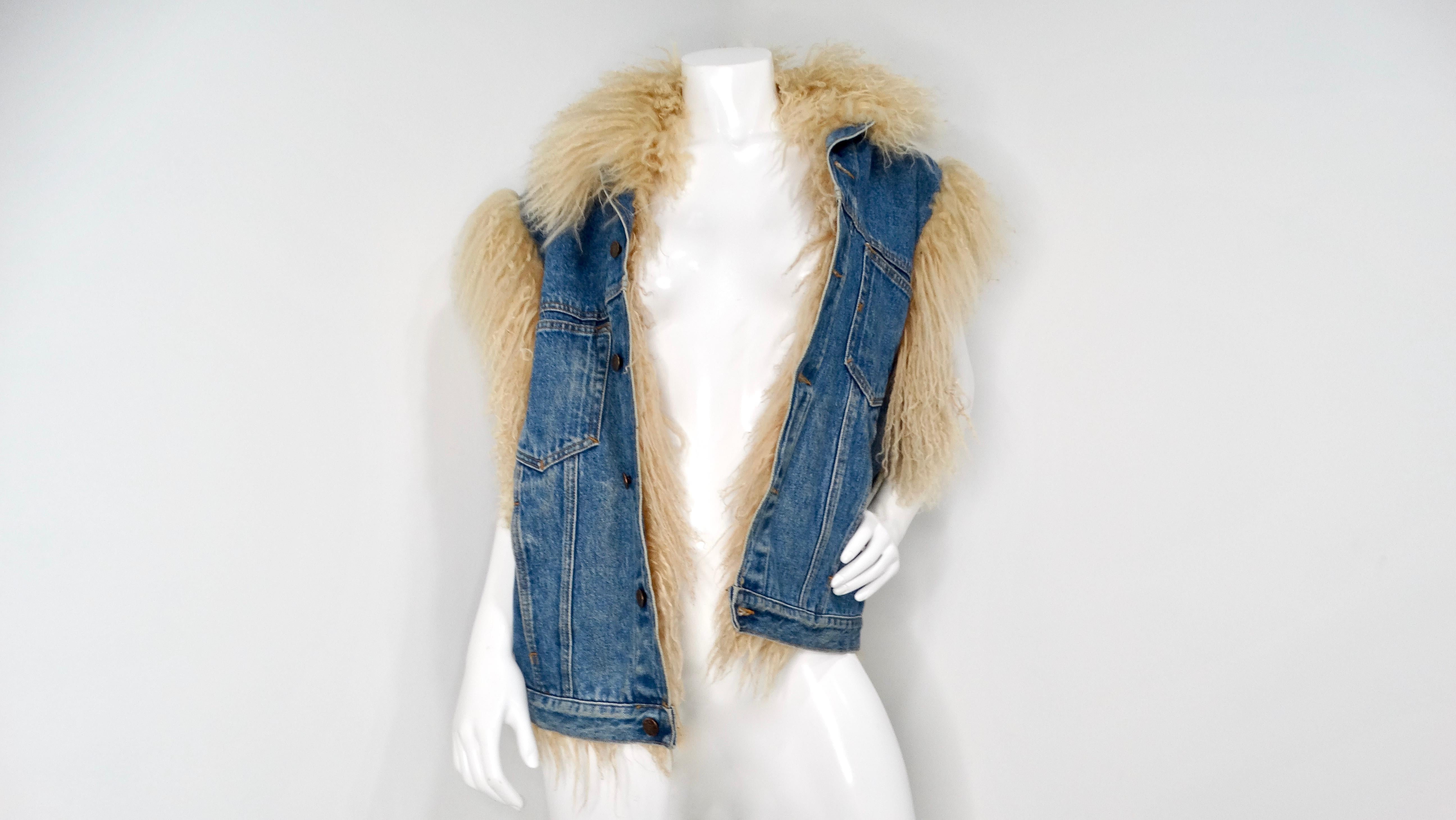 Step back into the vibrant and eclectic 1990s with this stunning Denim Blue Mongolian Lamb Fur-Lined Vest. A true statement piece, this oversized blue denim vest combines the ruggedness of denim with the playful luxury of Mongolian lamb fur. The