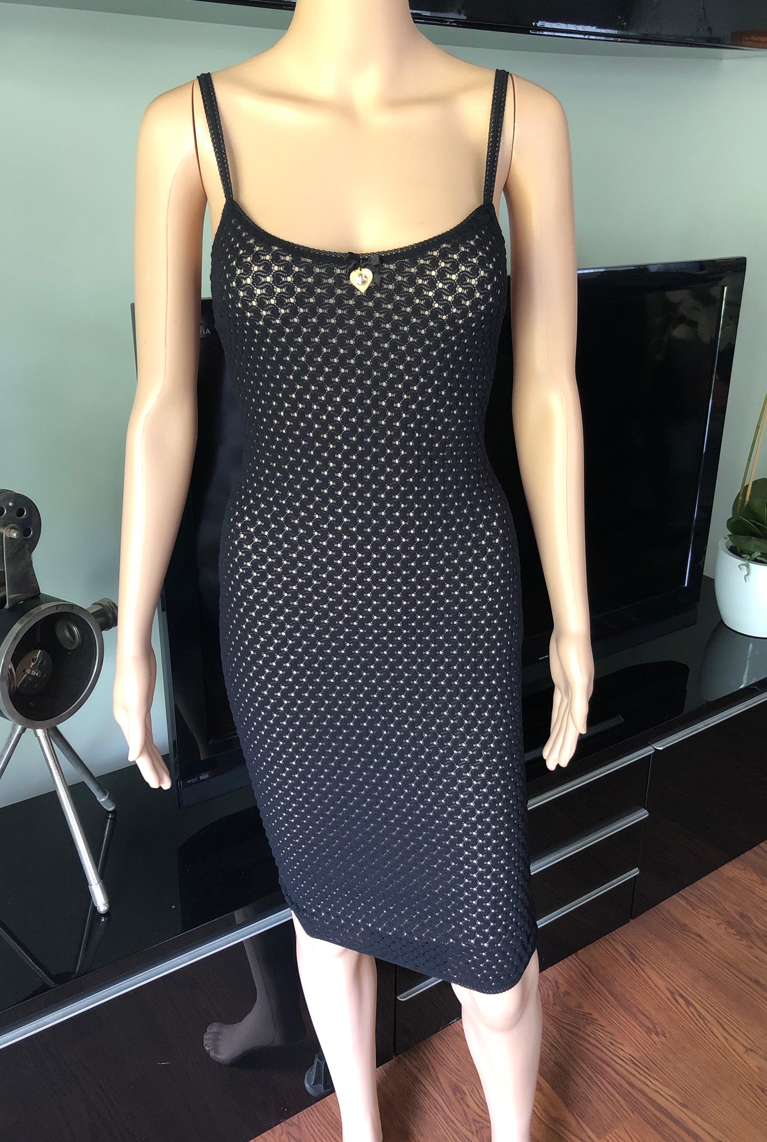 1990's D&G by Dolce & Gabbana Sheer Knit Fishnet Mesh Black Dress w Virgin Mary Charm IT 38

D&G by Dolce & Gabbana mesh knit mini dress with scoop neckline, embellished virgin mary charm accent at bust and slip underlay.
