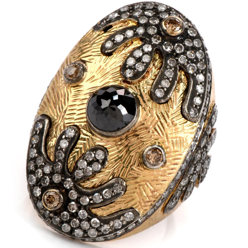 This fanciful Estate octagonal-shaped large cocktail ring crafted in 14K yellow gold features fine textural details on top and the back of the band. The ring is centered with one round fancy cut cabochon black diamond and adorned with a border of