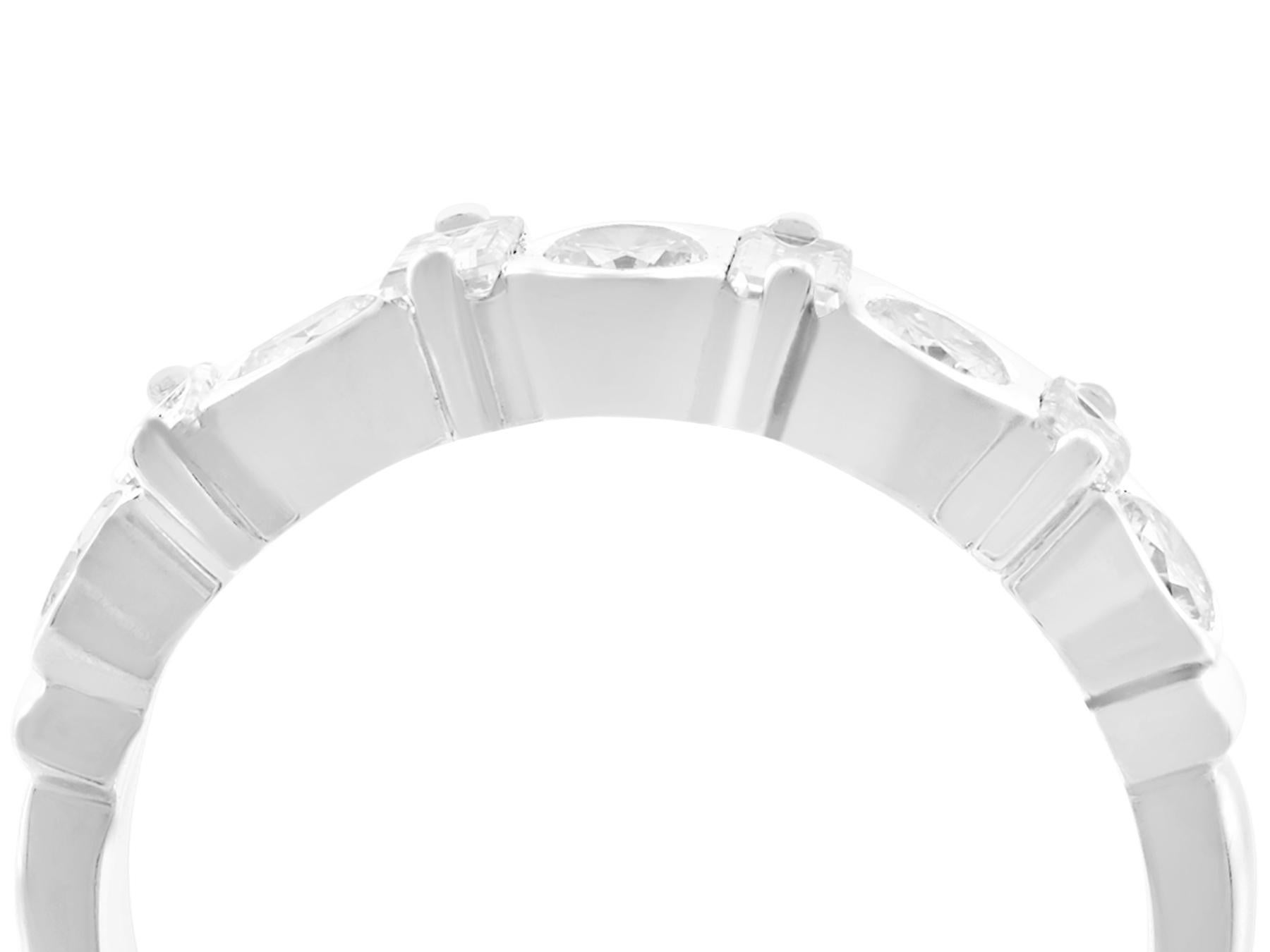 A fine and impressive vintage 0.95 carat diamond, 18 karat white gold half eternity ring; part of our diverse vintage jewelry/estate jewelry collections.

This impressive unusual diamond half eternity ring has been crafted in 18k white gold.

The