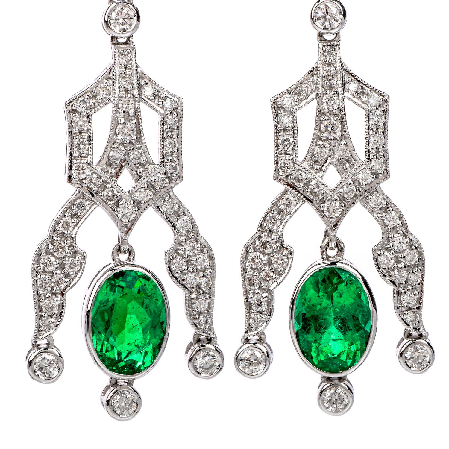 Feel the enchantment of these vivid Estate Diamond 18K Gold 6.22ct Oval Drop Dangle Earrings!  These lovely, deco- inspired earrings are crafted in 18 karat white gold. 
There are two genuine emeralds, oval shaped, bezel set, of approximately 3.88