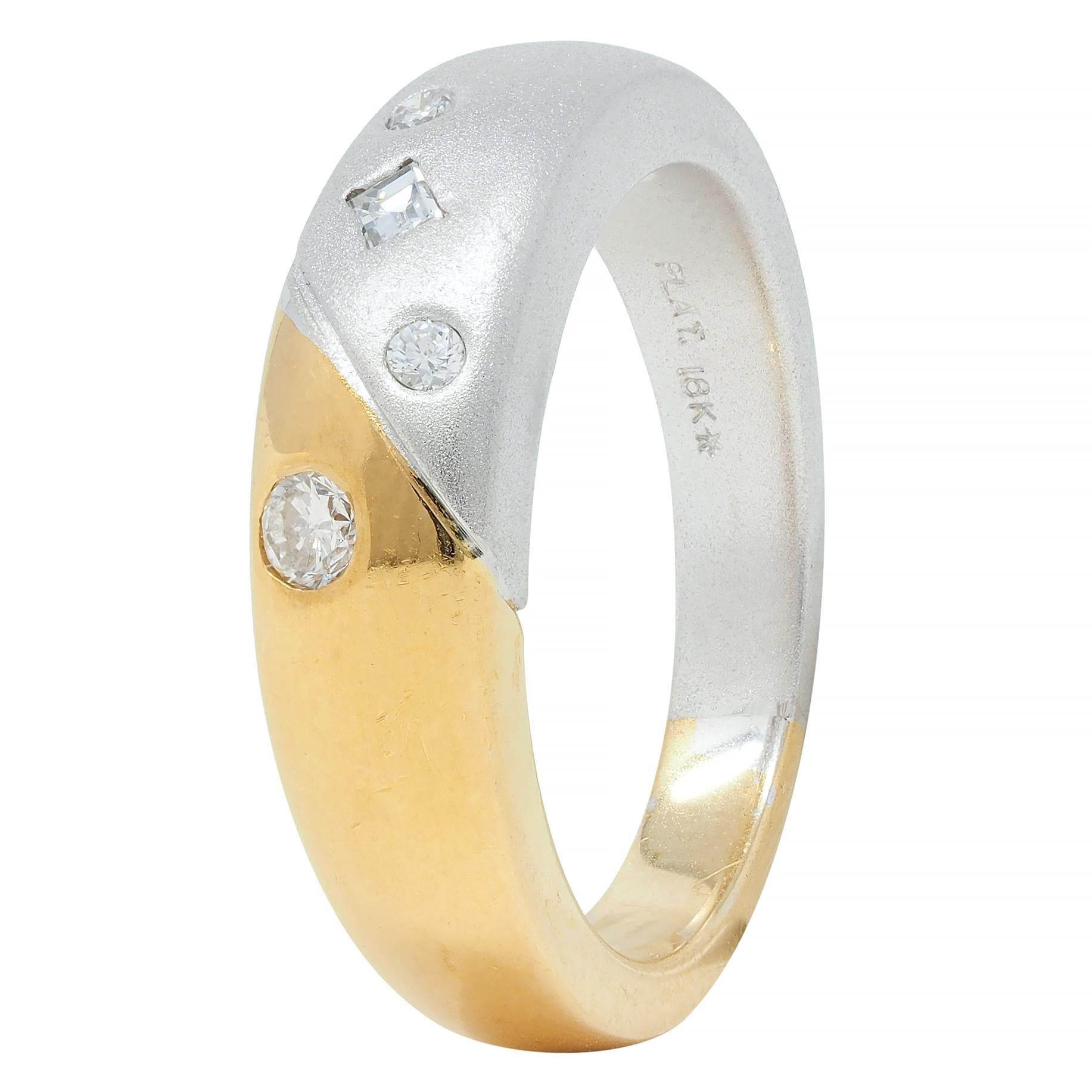 Featuring one half matte platinum and the other high polished yellow gold 
Meeting at grooved slash motif in center - with diamonds throughout
Step and round brilliant cut weighing approximately 0.15 carat total
Eye clean and bright - flush set in