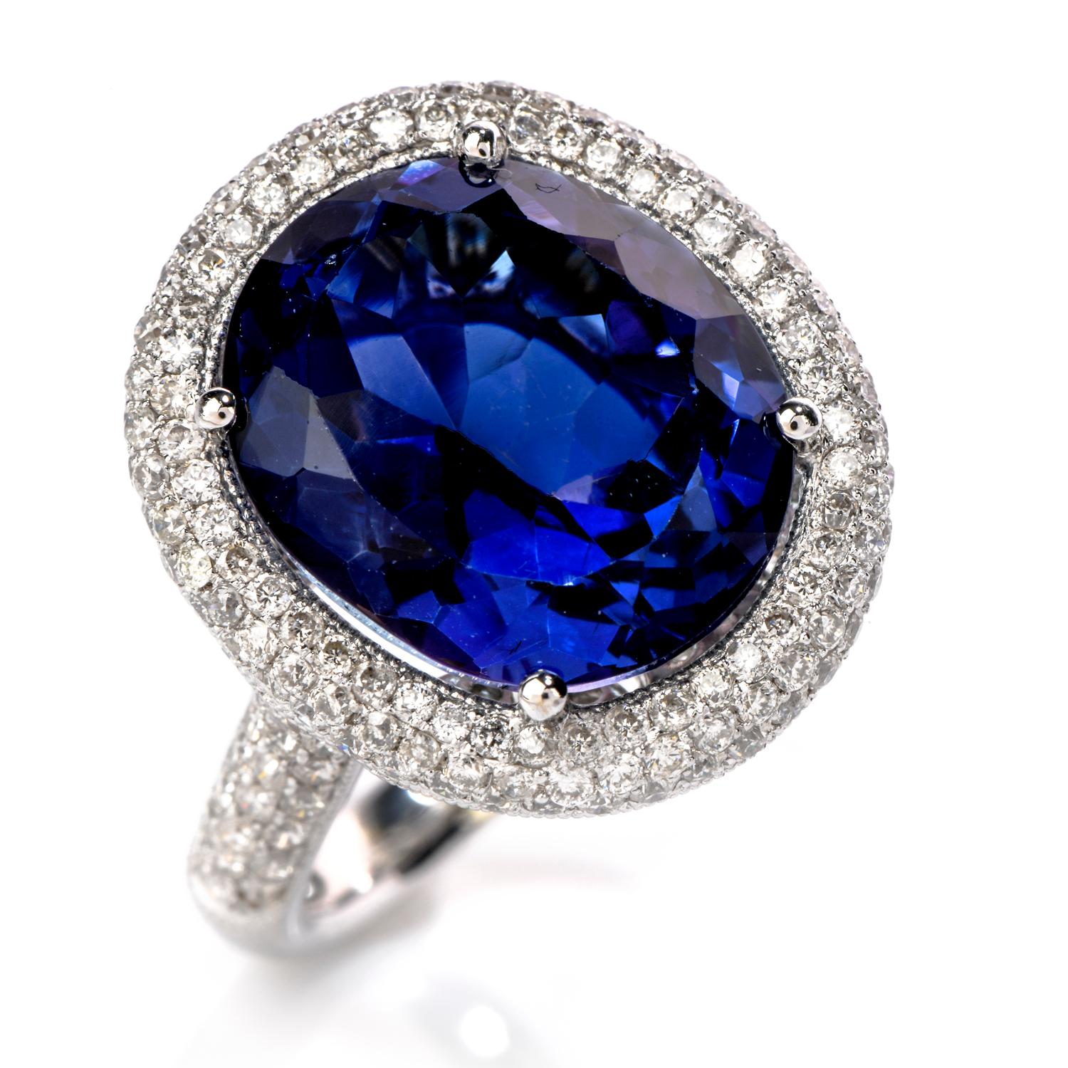 Dive in the deep blue ocean with this romantic Diamond Tanzanite 18K Gold Oval Halo Cocktail Ring!  Centered with one genuine oval cut tanzanite of 9.80 carats surrounded by various round cut diamonds of a total of 2.58 carats, F-G color, and VS