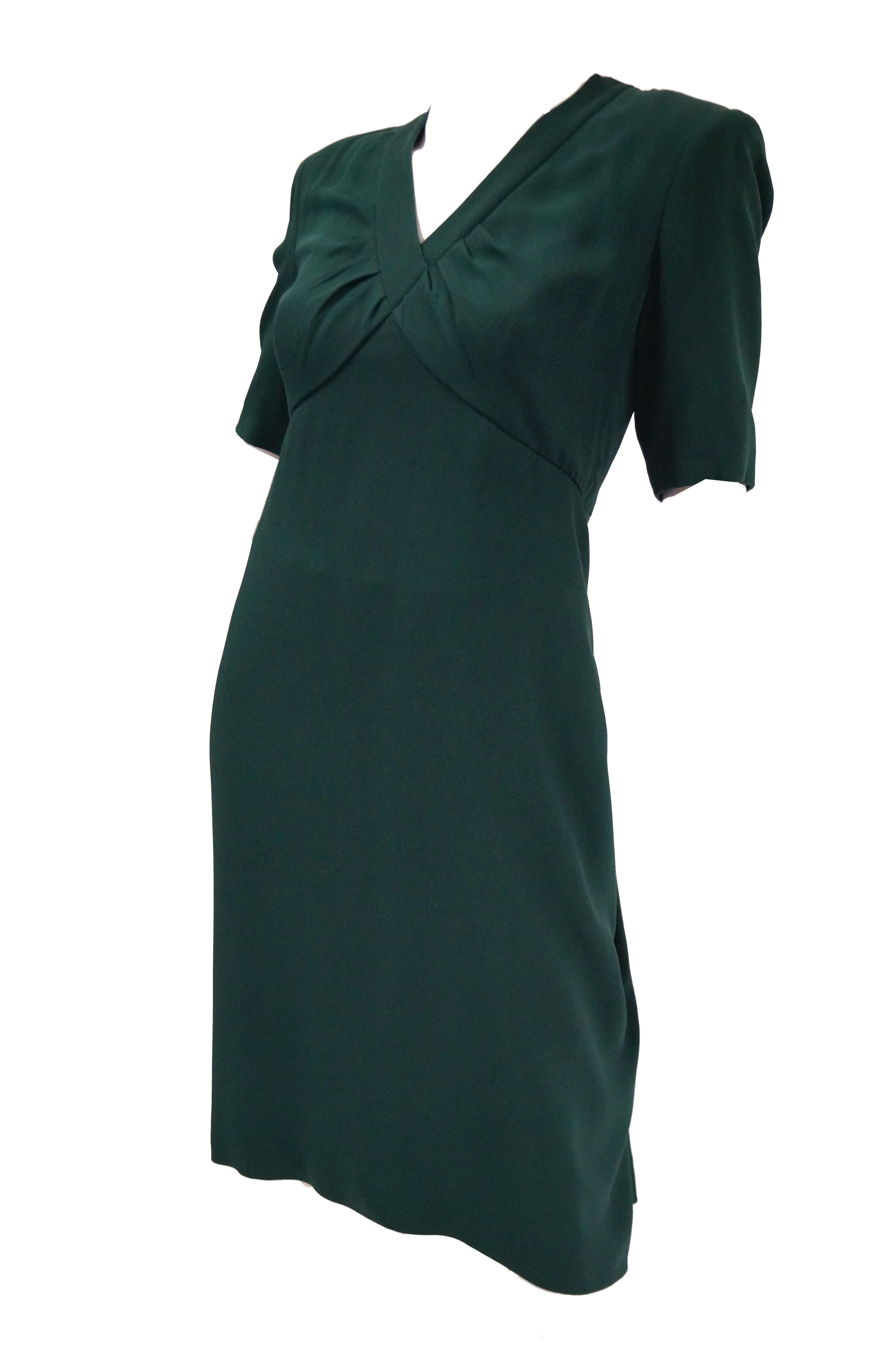 Elegant and understated haute couture dress by Gianfranco Ferre for Christian Dior. The forest green dress is knee length, with sleeves that fall just above the elbow, and a V - neck collar. The dress has a loose sheath silhouette with empire waist