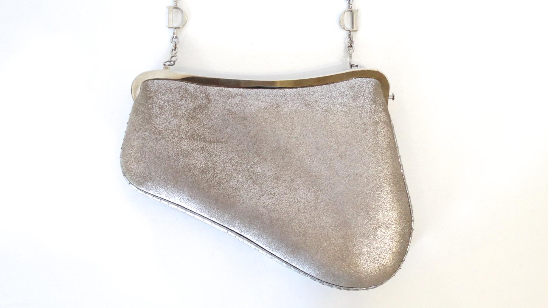 Show Off Your Inner 90s Girl! Circa 1990s, this Dior mini saddle bag is made of leather with a metallic silver finish. Features tonal faux snake skin on the strap, bottom trim and on the front face of the bag. Silver plated hardware all throughout.