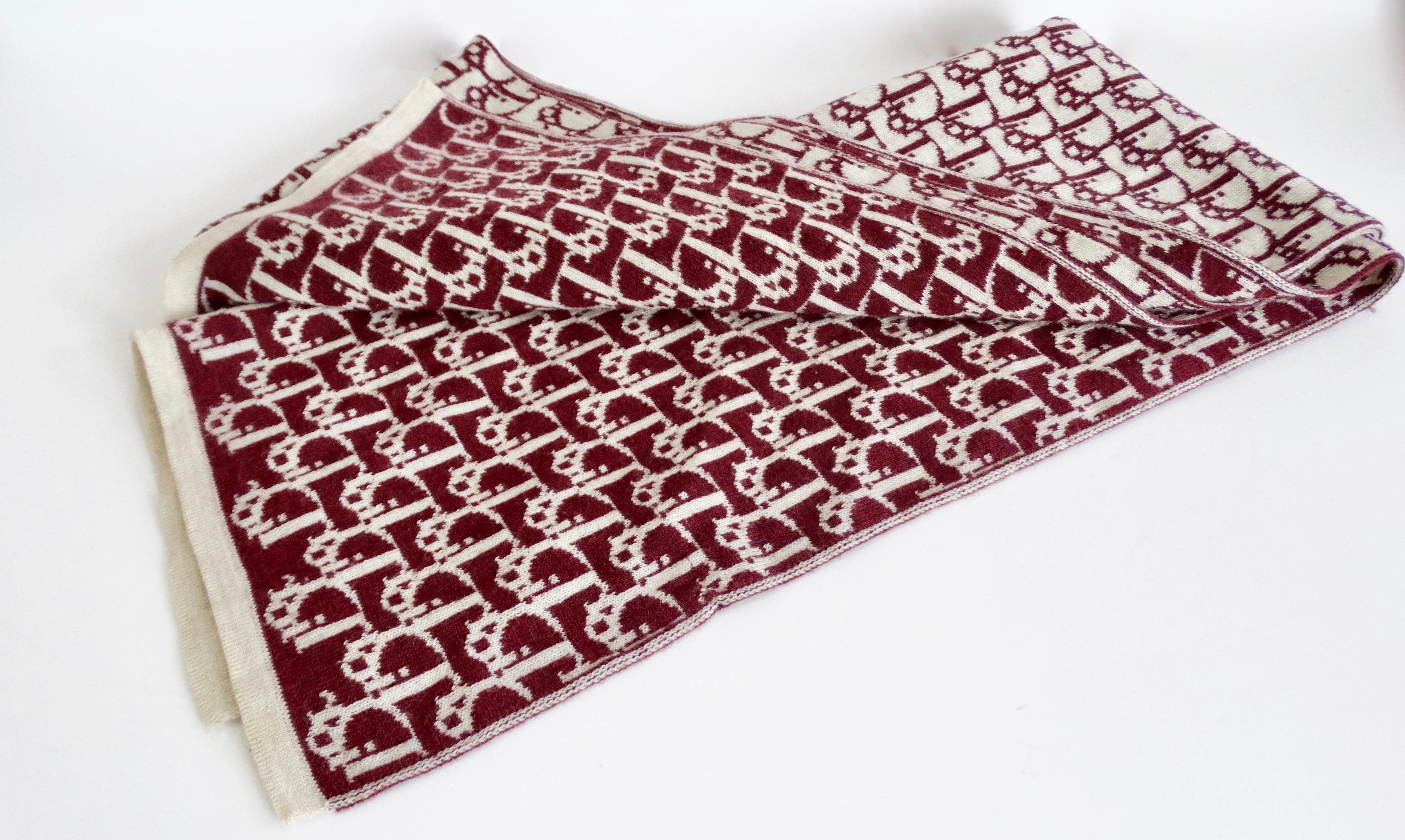 Stay cozy all winter long with this Dior scarf! Circa 1990s, this extra long scarf is made of extra soft wool and features the Dior monogram in maroon letters with a cream background, and vice versa on the back. The perfect scarf to throw on with