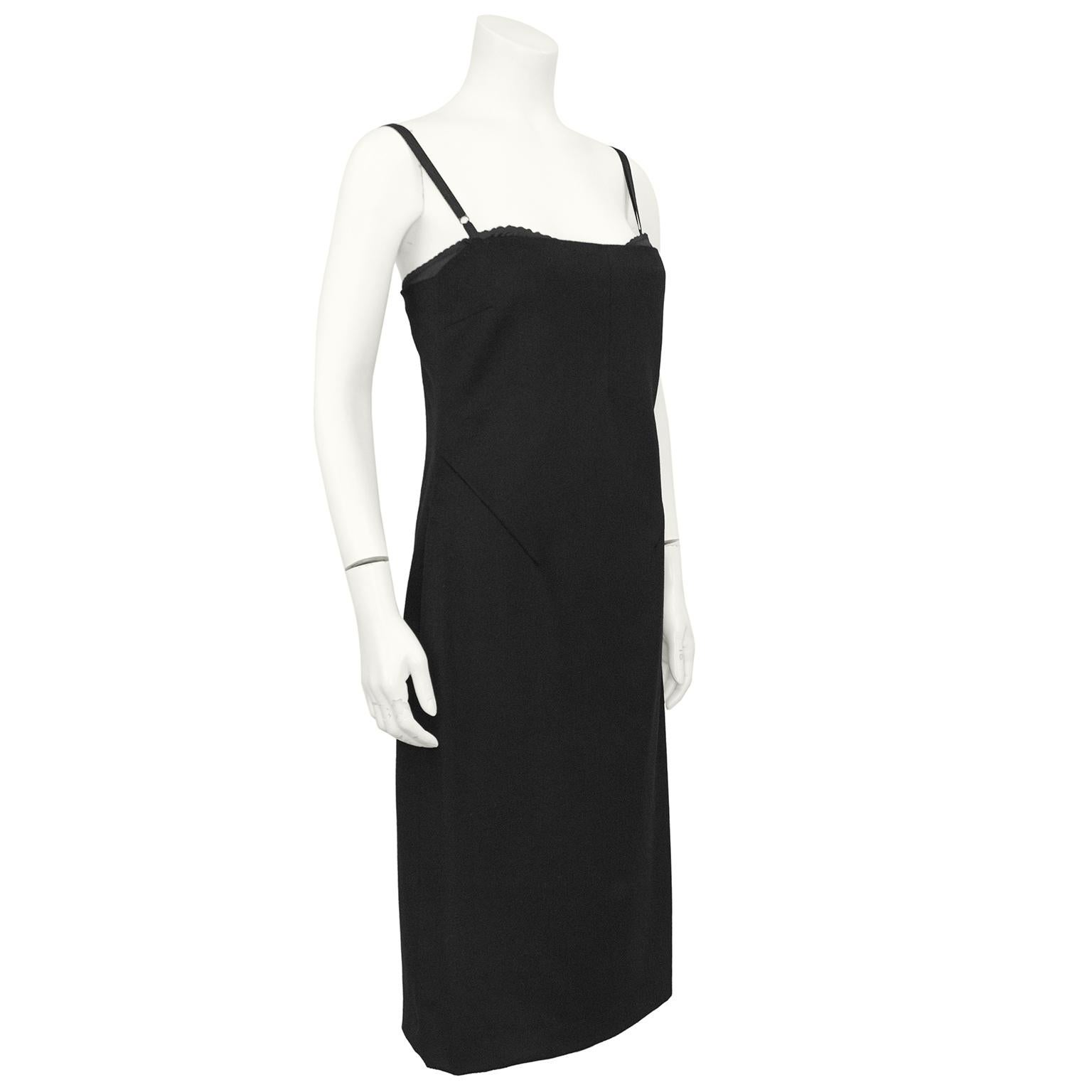 Sleek and sexy Dolce and Gabbana black cashmere cocktail dress from the 1990s. The dress skims the body beautifully and has a straight neckline. The top of an inserted black silk bra is visible with adjustable spaghetti straps. Beautiful seam work