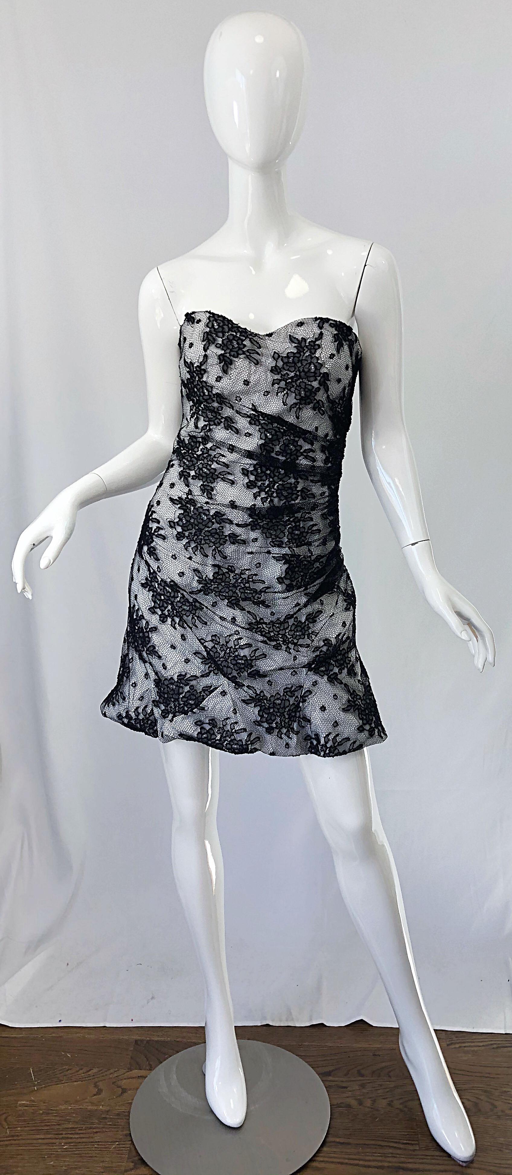 Sexy late 1990s vintage DOLCE & GABBANA black and white lace strapless mini dress! Features interior boning to keep everything in place. Full metal zipper up the back with hook-and-eye closure. Ruching at the skirt add a sculptural aspect to the