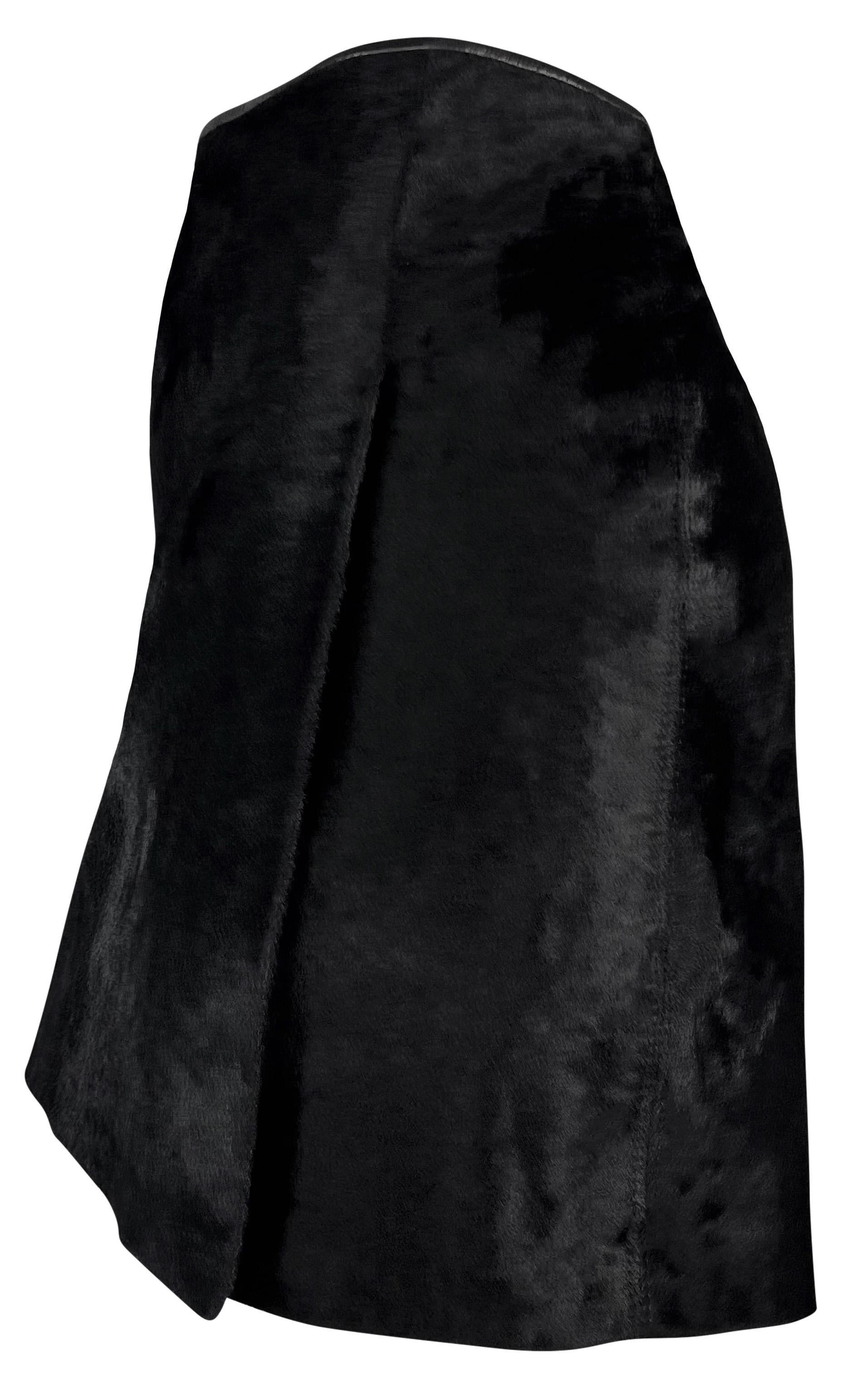 From the late 1990s, this black ponyhair Dolce & Gabbana wrap-style mini skirt is constructed entirely of shiny cowhide. 

Approximate measurements:
Size - 46IT
Waistband to hem: 16