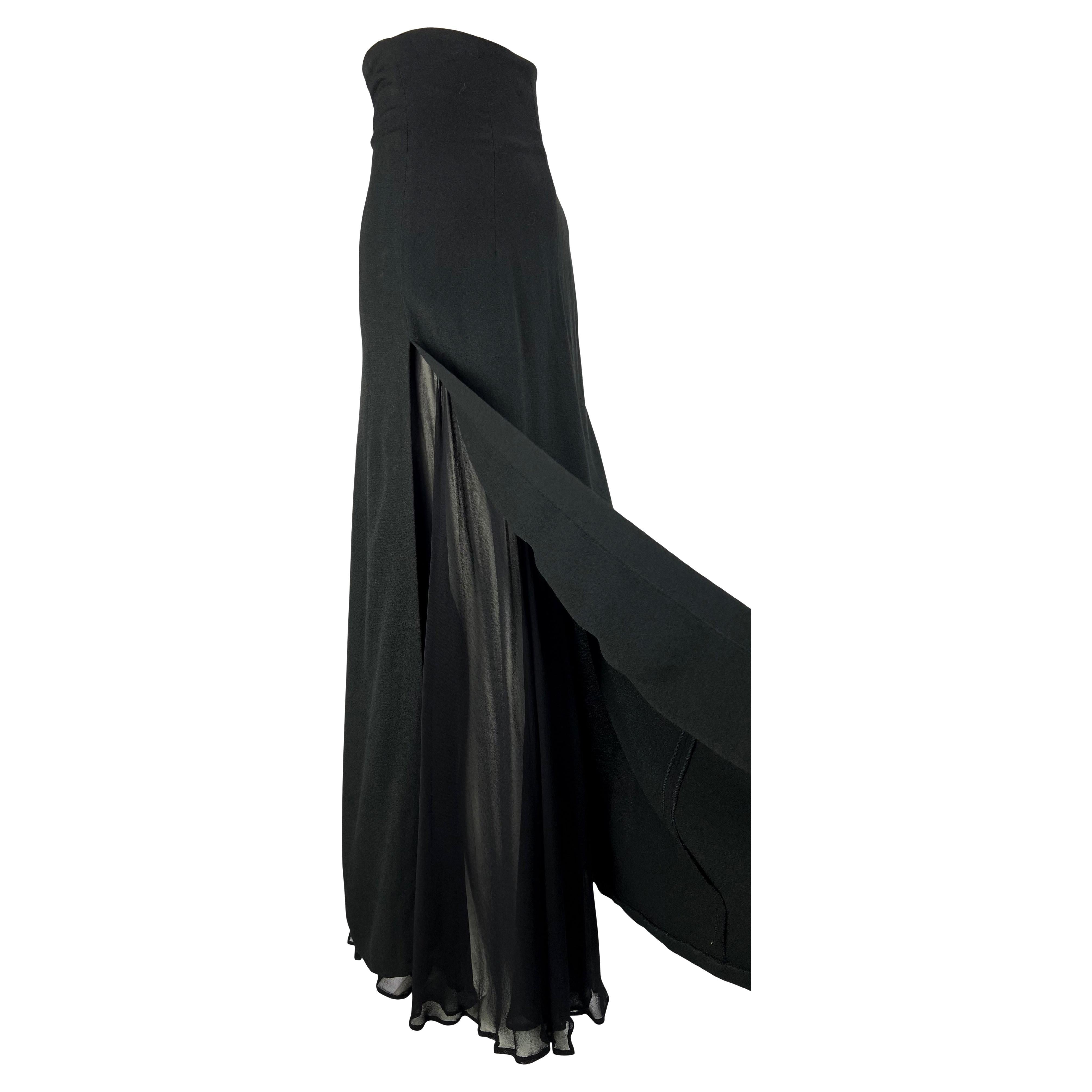 Presenting a high-waisted Dolce & Gabbana maxi skirt with a chiffon underskirt. Designed in the 1990s, this piece features a high-thigh slit that reveals the sheer black chiffon underskirt. The high-waist slims the silhouette to create the classic