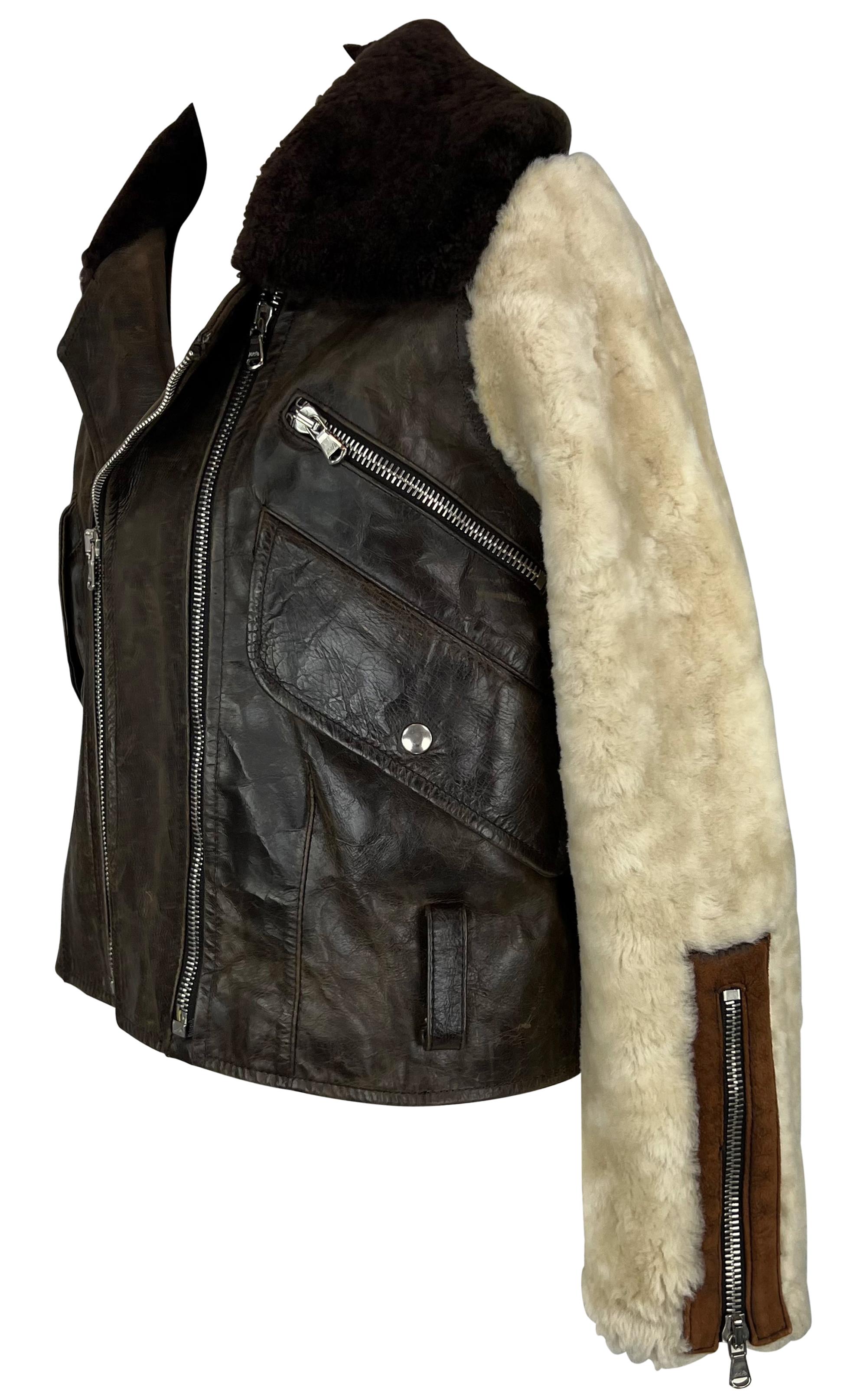 This 1990s Dolce & Gabbana aviator / moto jacket is crafted from distressed brown leather with contrasting shearling fur sleeves and collar, delivering a bold, tactile aesthetic. The jacket features an oversized notched collar, double front zippers,