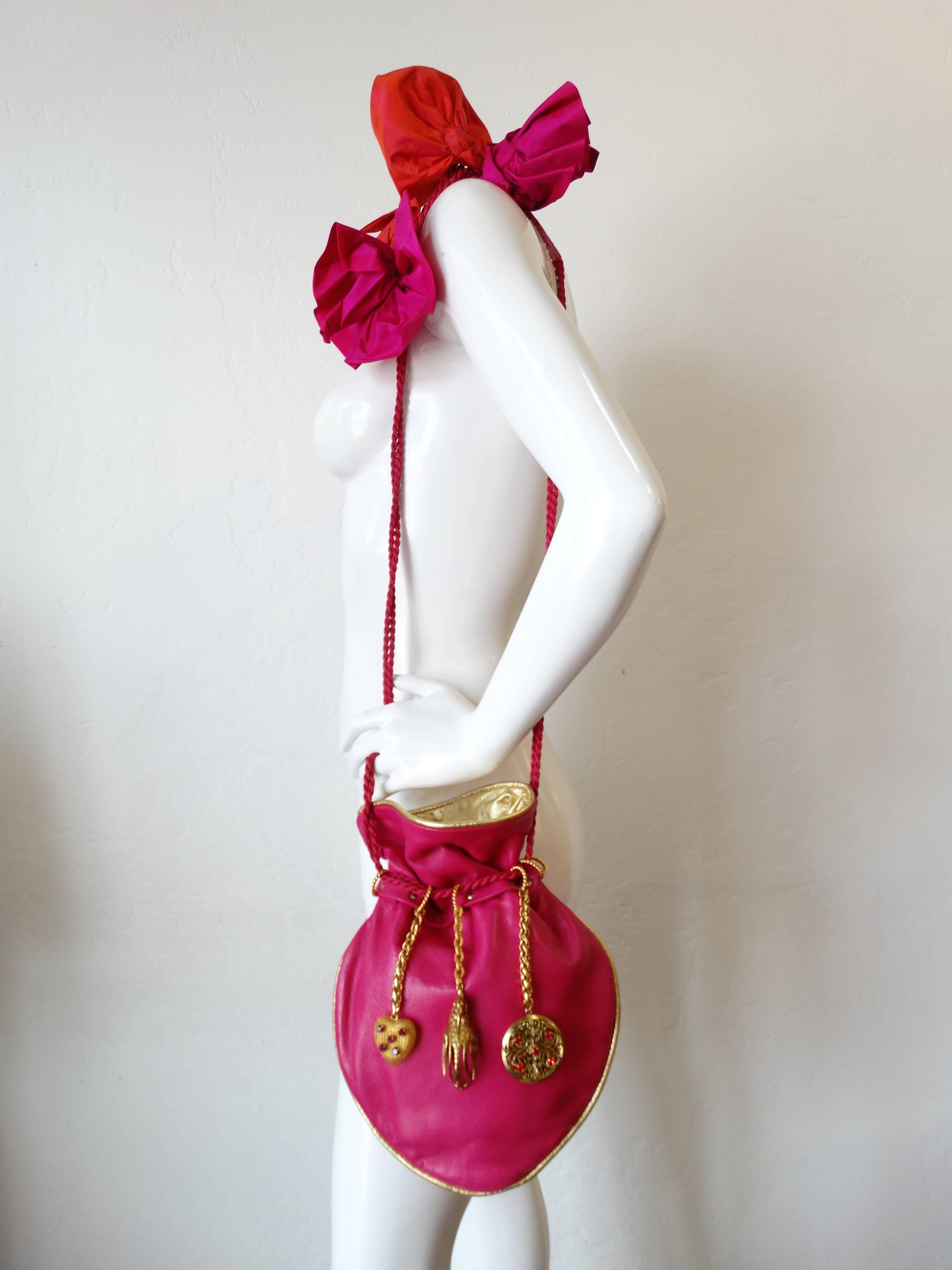Early 1990's Dominique Aurientis Charmed Handbag From Bullocks Wilshire. This is a Runway Couture leather charm handbag!  Has never been out on the town to show off it's unconventional, but funky and fun style.  Hanging bobbles, fabric flower