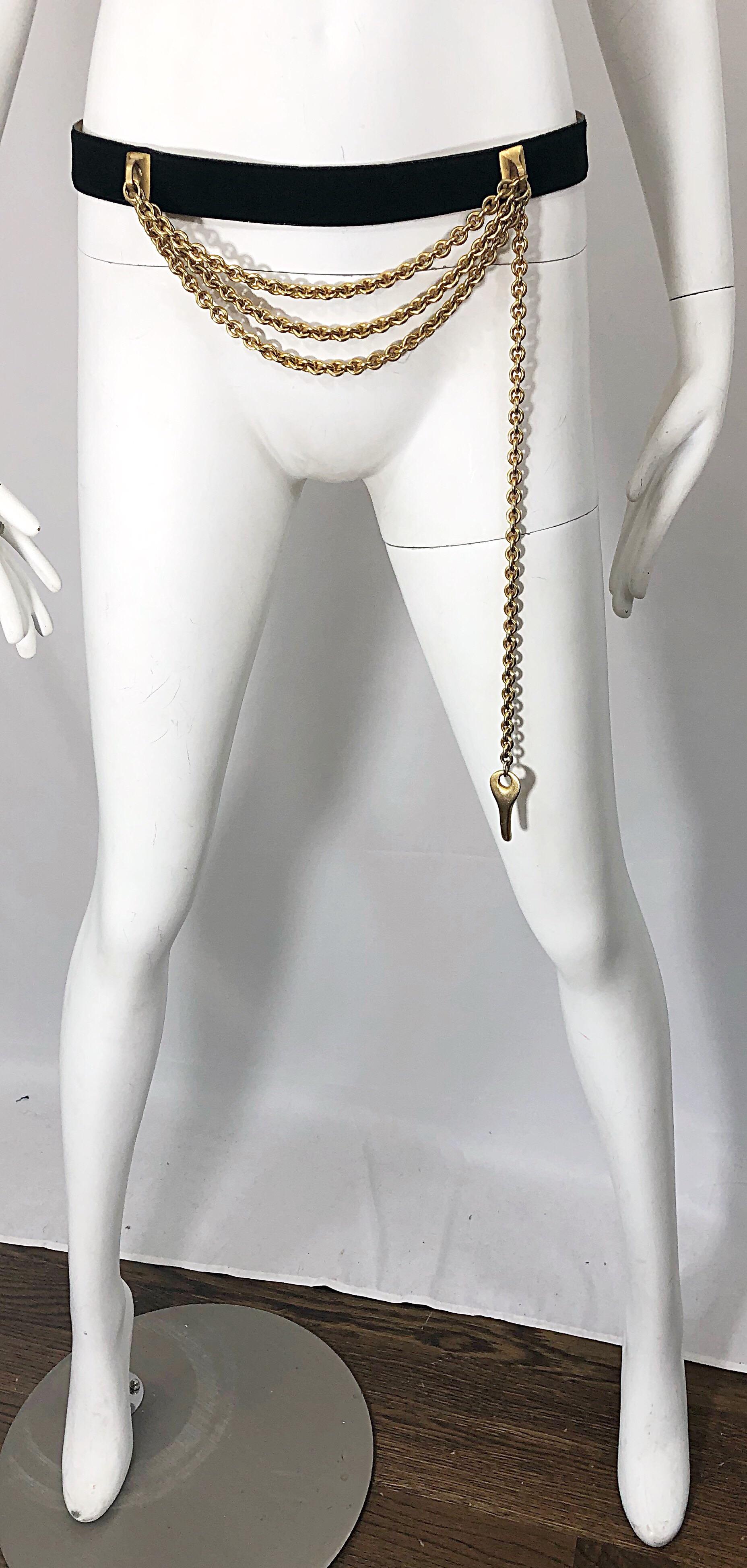 Chic early 90s DONNA KARAN black leather suede and gold chain key belt! Features a medium width belt that has three levels of chains across the front middle. Long key pendant can be worn hanging, or can loop into one of the metal slots (as seen in