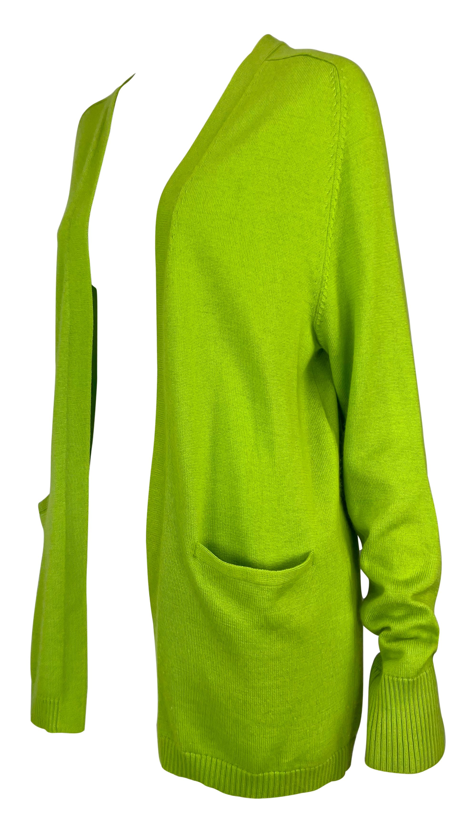This bright green Donna Karan cardigan features an open-front design with two front pockets and ribbed cuffs. Its long sleeves and relaxed fit make it a versatile and comfortable layering piece, perfect for adding a pop of color to any