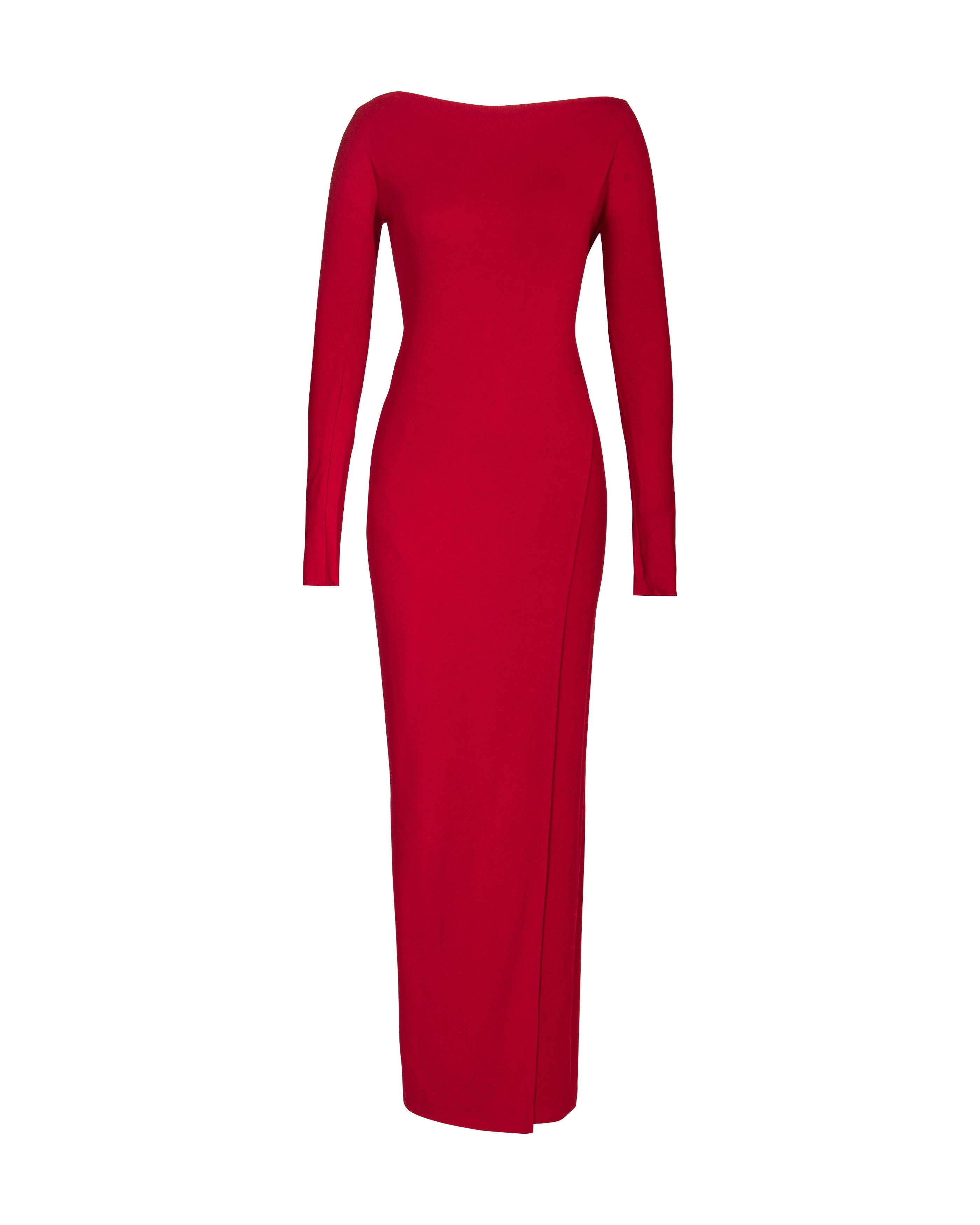 1990's Donna Karan red long sleeve jersey asymmetrical gown. Long sleeve gown with bateau neckline and asymmetrical-style high slit wrap dress interior at right side. Built-in elasticized waistband. Can be styled with wrap to front or back depending