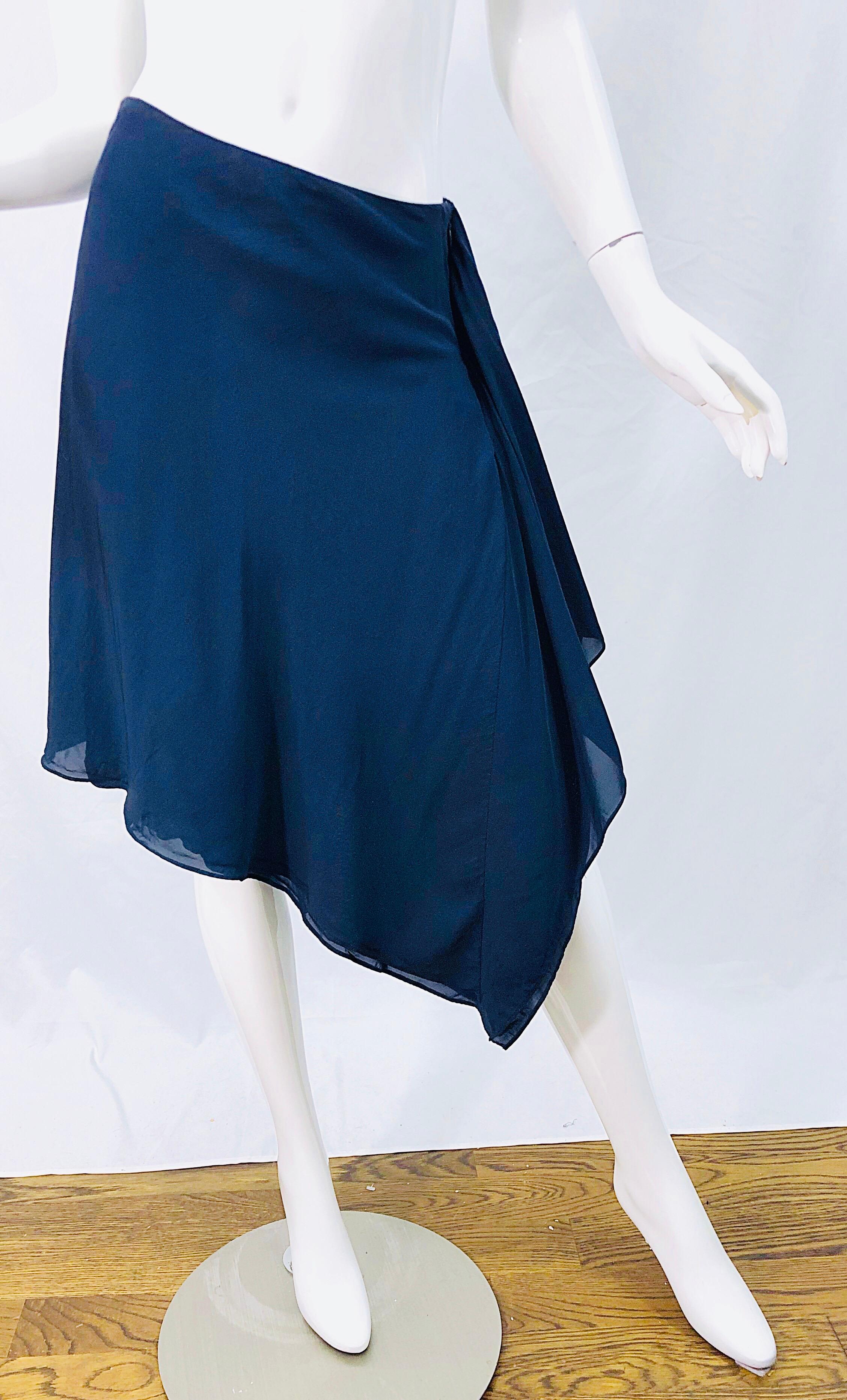 Chic late 1990s DONNA KARAN navy blue handkerchief hem rayon wrap skirt ! Features a dark navy color that is perfect for any time of year. Wrap style with interior button and hook-and-eye closure. Soft rayon fabric. 
Can easily be dressed up or
