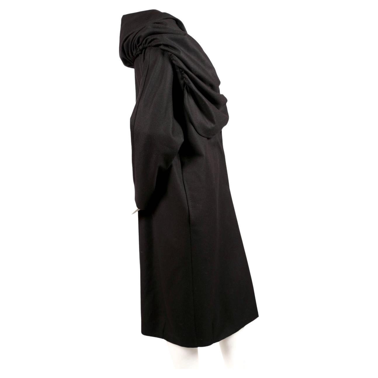 Jet-black, wool opera coat with dramatic ruched shawl collar designed by Dries Van Noten dating to the early 1990's. Labeled a size 'XS' however this can easily also fit a small or possibly a medium due to the generous cut. Approximate measurements: