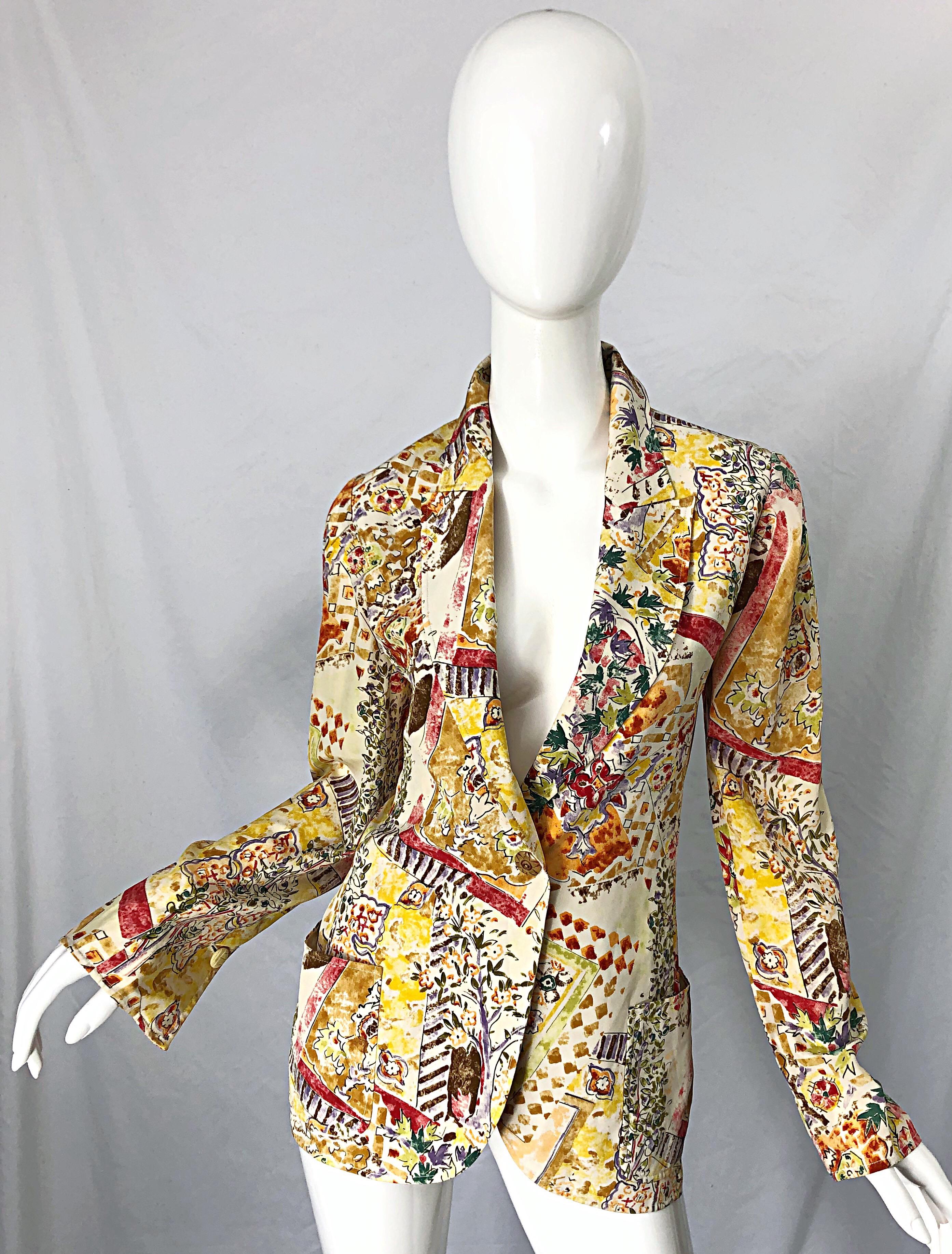 Chic mid 90s EMANUEL UNGARO garden flower print silk blazer jacket ! Features vibrant colors of yellow, green, purple, burgundy, orange, and ivory throughout. Single button closure. Pockets at each side of the waist. Perfect layered or alone. 
In