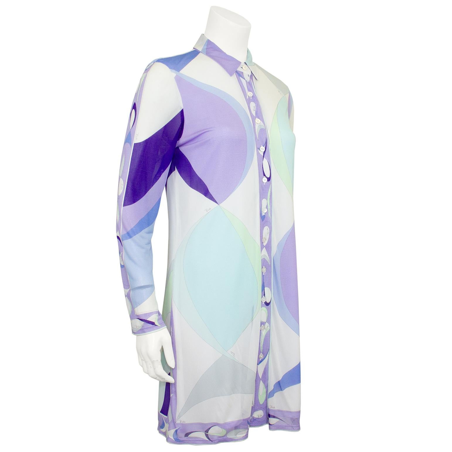 Great Emilio Pucci piece from the 1990s. Abstract printed sheer with shades of pale blues, lavender and deep purple. Body is lined and very slightly sheer, sleeves are unlined and sheer. Can be worn with jeans or as a bathing suit cover up when on