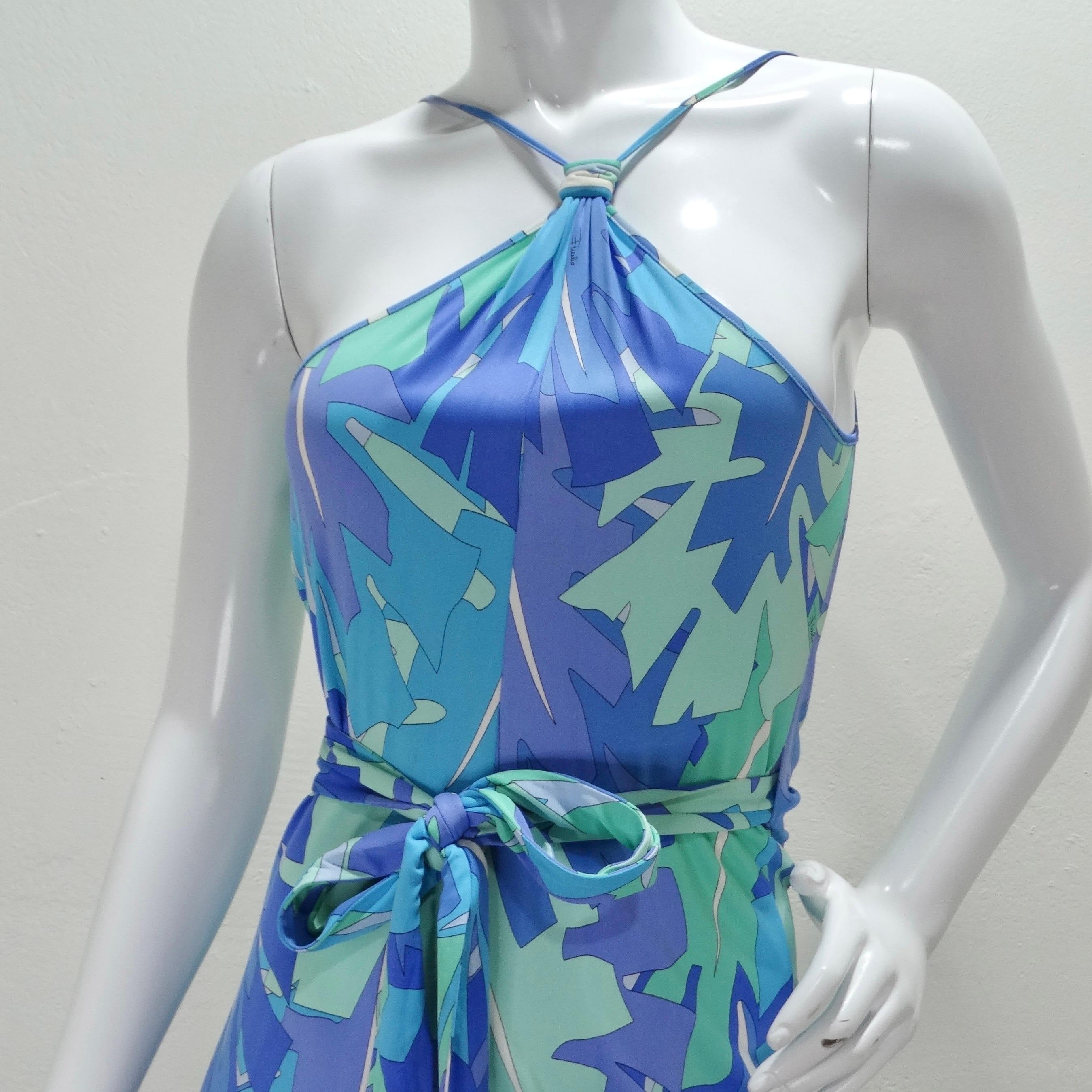 Get your hands on this magical 1990s Emilio Pucci halter wrap dress! Emilio Pucci presents his signature whimsical graphic this time in a serene pallet of blue shades  that come together to create this vibrant and eye catching print. An elegant
