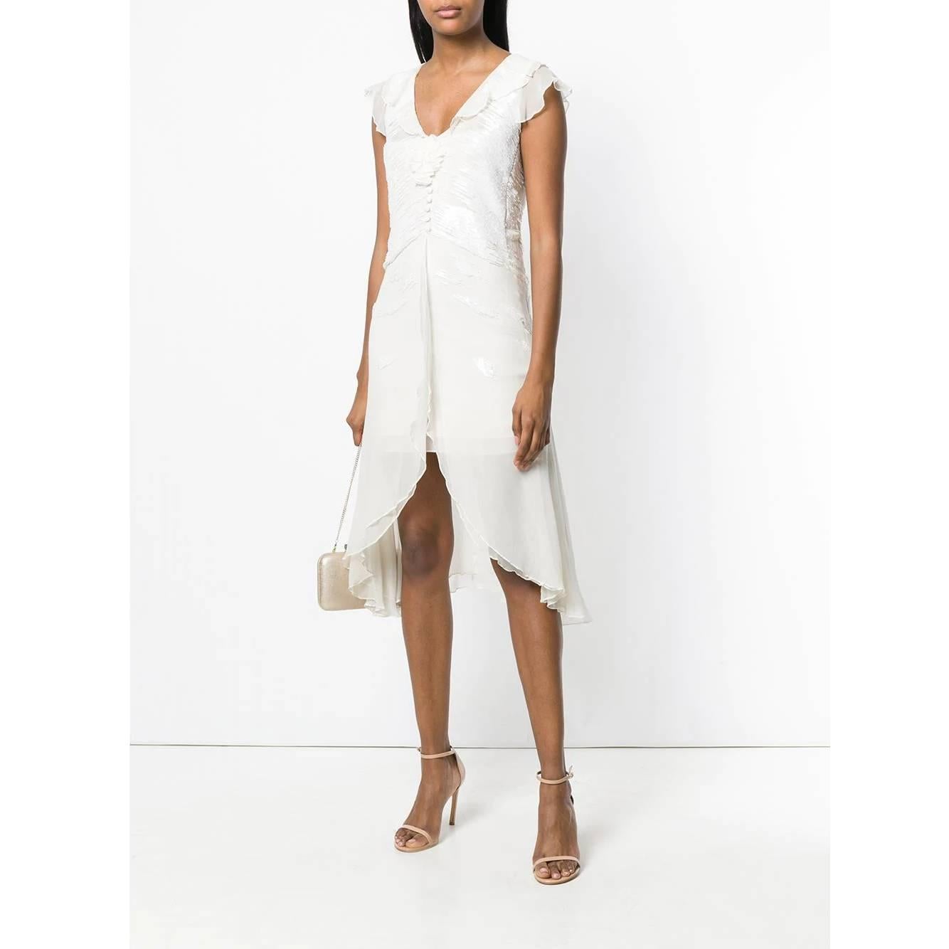 A.N.G.E.L.O. Vintage - Italy
Emporio Armani white semitransparent organza wedding dress. Model with V-neck and asymmetrical cut; white beads, ruffles on the shoulders, front covered buttons and applied flower. Back zip closure. Not provided with