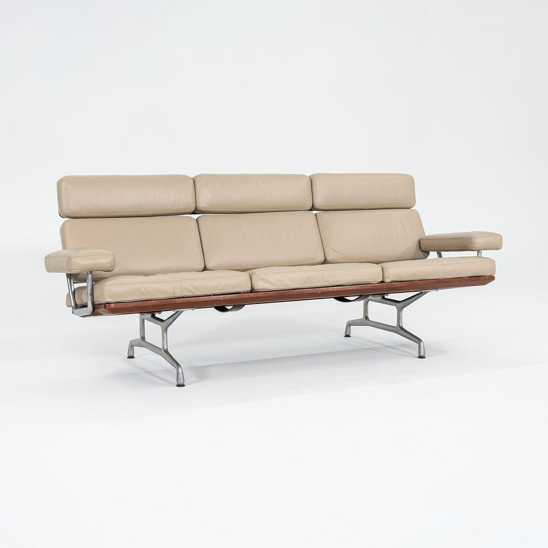 This is an ES-108 Three-Seat Teak Sofa, initially designed by Ray and Charles Eames for Herman Miller in 1984. This example dates to the 1990s. Its design consists of a solid aluminum frame with teak plank details, and has removable upholstered seat
