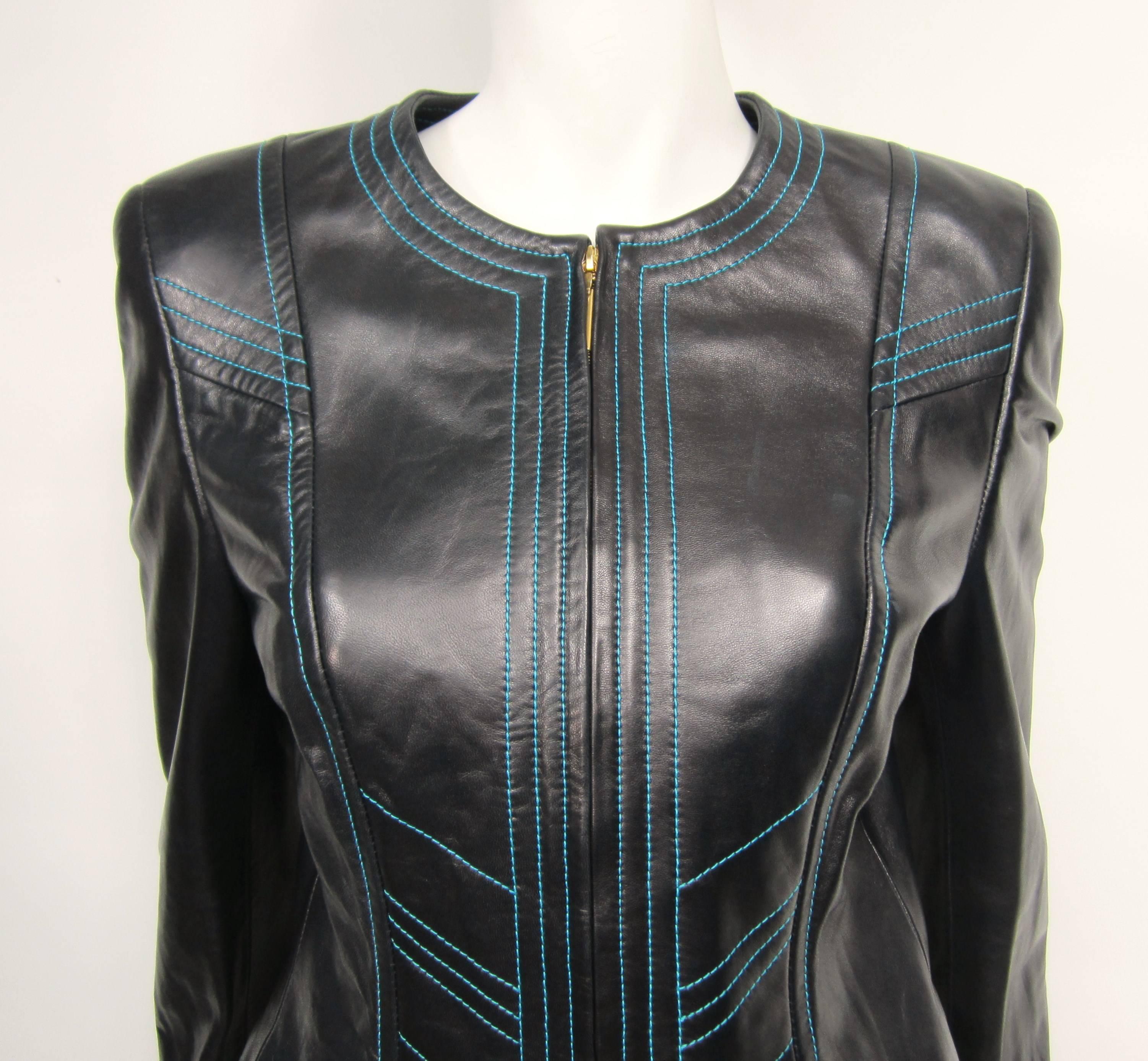 Black Leather Escada Jacket with Bright Blue Stitching. Gold Tone zipper detailing. Matching skirt is on our store front as well. Measuring - Up to 36 Bust  - Up to 30 waist  - Length is 21.25 - Sleeve 23.5 inches. Please check our storefront for