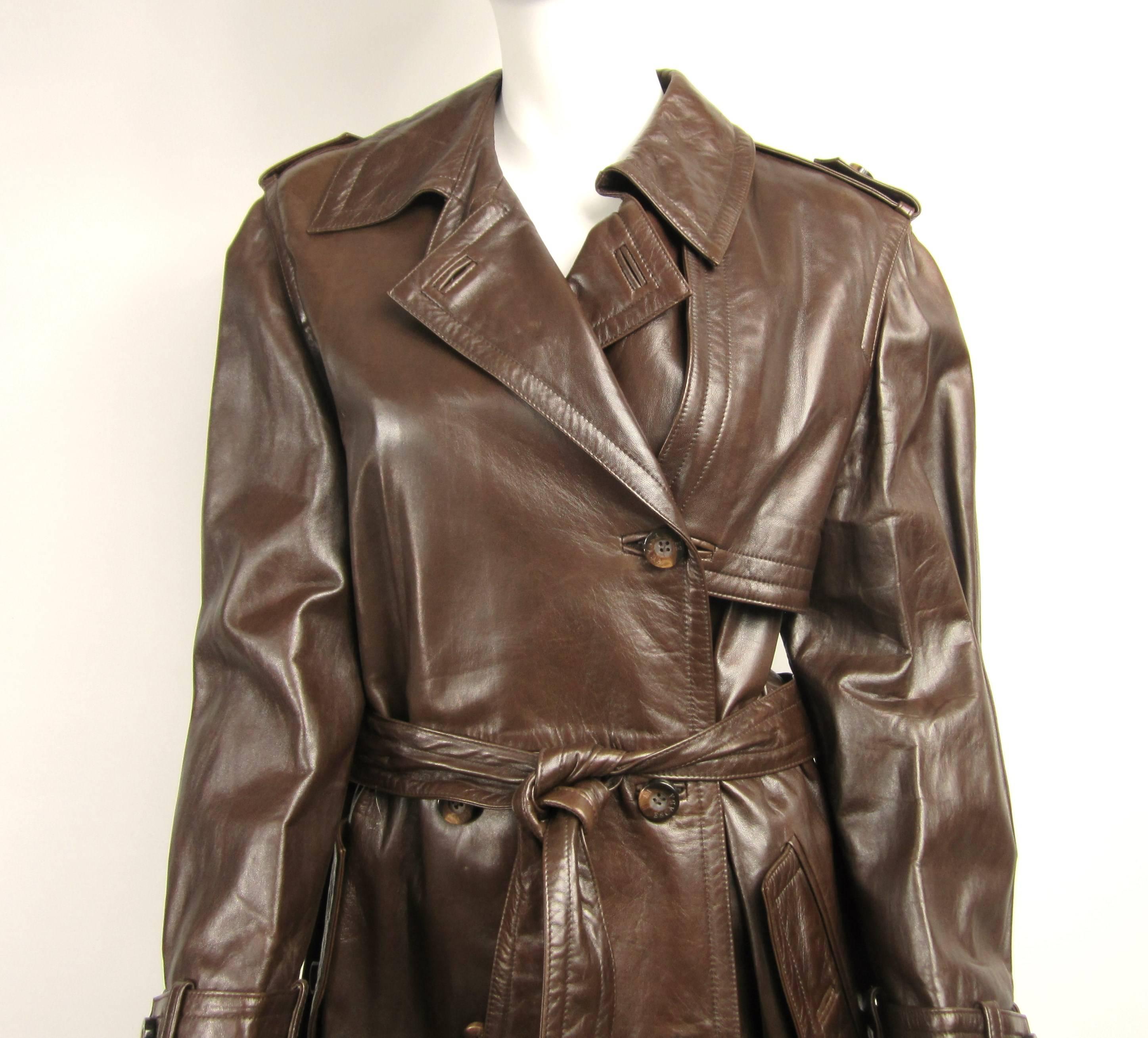 Stunning supple Escada Brown Leather trench coat. Detailing on this is fantastic. Buttoned Kick pleat in the back, detailing on the cuffs, pockets and belt. Buttons fasten the belt to the coat. This was purchased back in the late 1980s early 1990s