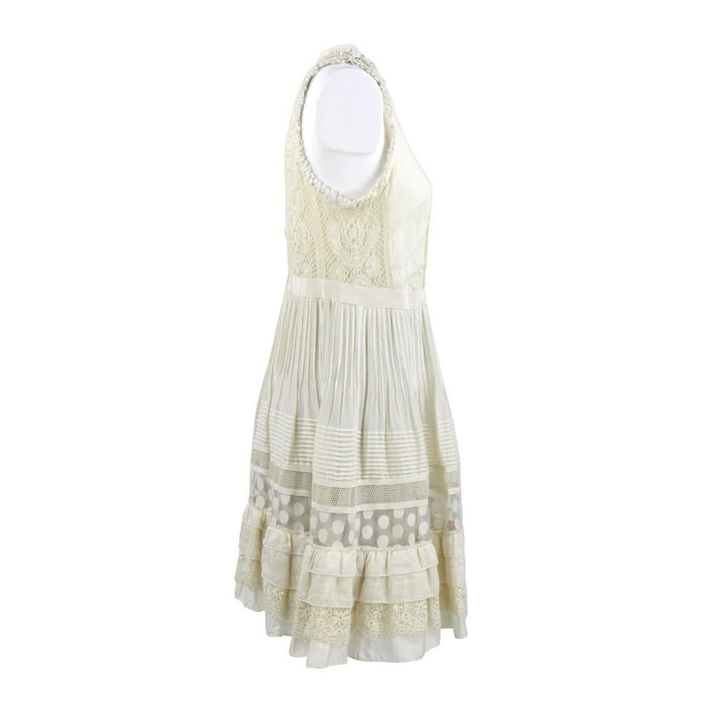 Etro ivory silk blend cotton dress. Model with round neckline, sleeveless and front buttons. Flared skirt with flounces on the bottom, pleated, lace and tulle details.

Years: 90s

Made in Italy

Size: 42 IT

Flat measurements

Height: 96 cm
Bust: