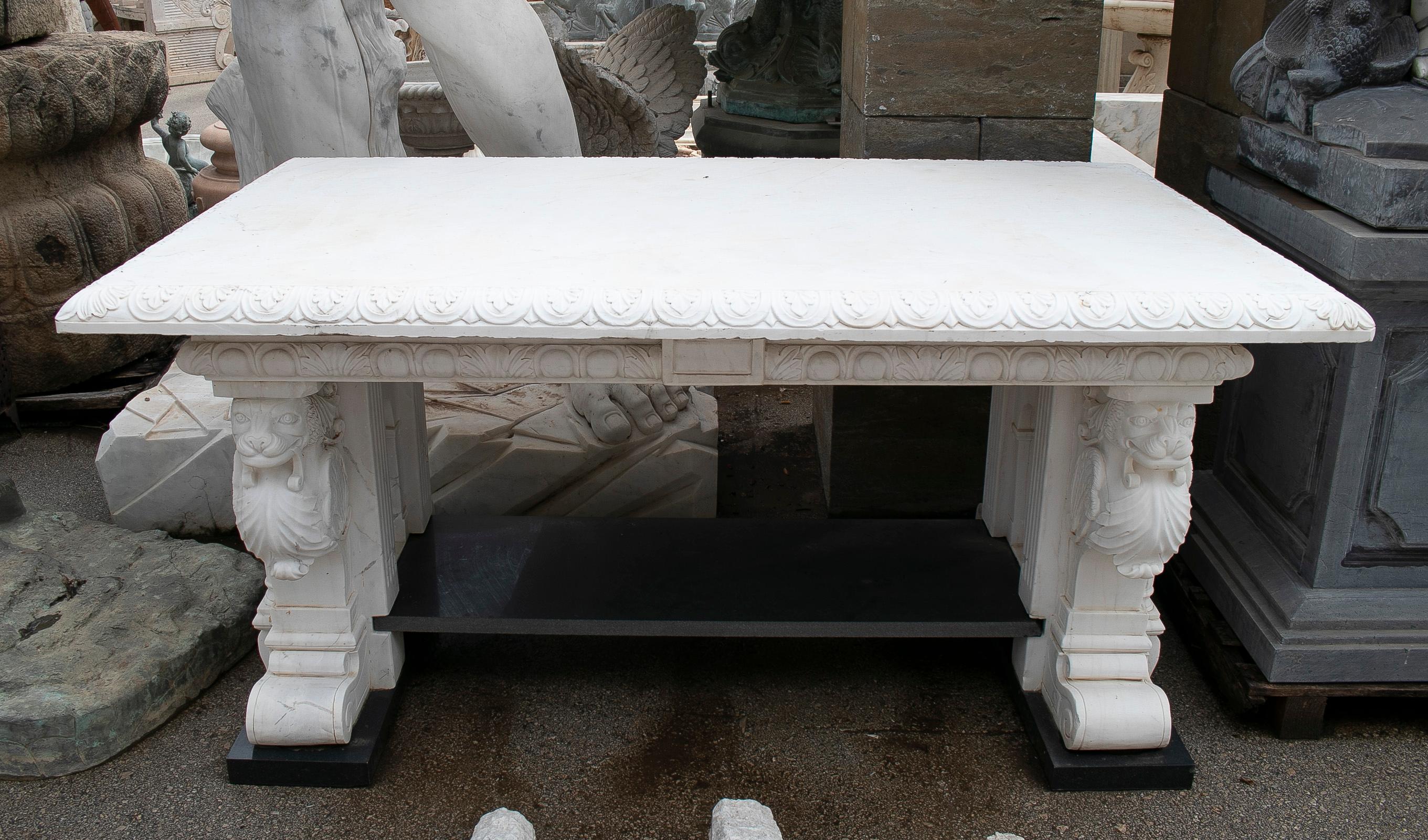 Classical style 1990s European hand carved white and black marble altar table with lionheads on bases.