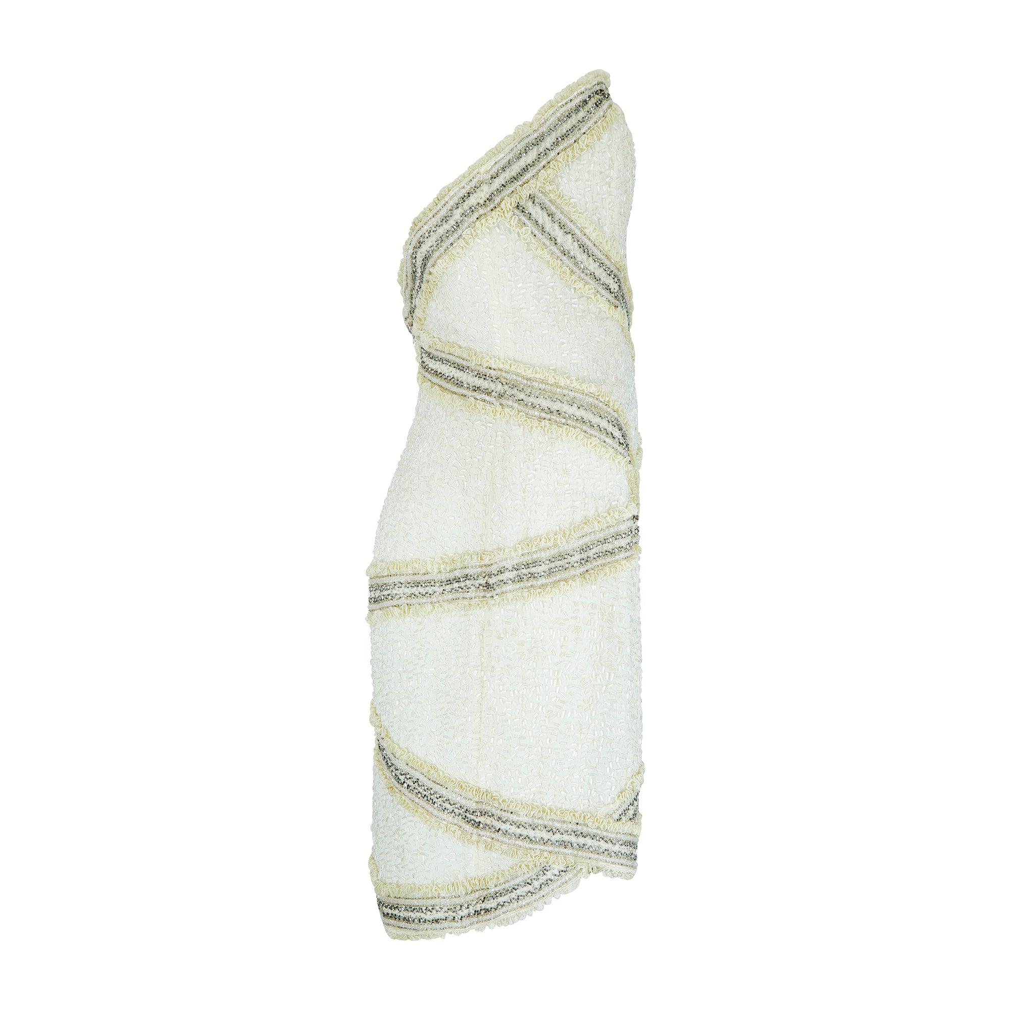 This decadent, rich cream mini-dress was created in the early 1990s by Fabrice, a renowned New York fashion label at the time which has now somewhat faded into obscurity. Founded by Haitian-born American fashion designer Fabrice Simon, the young