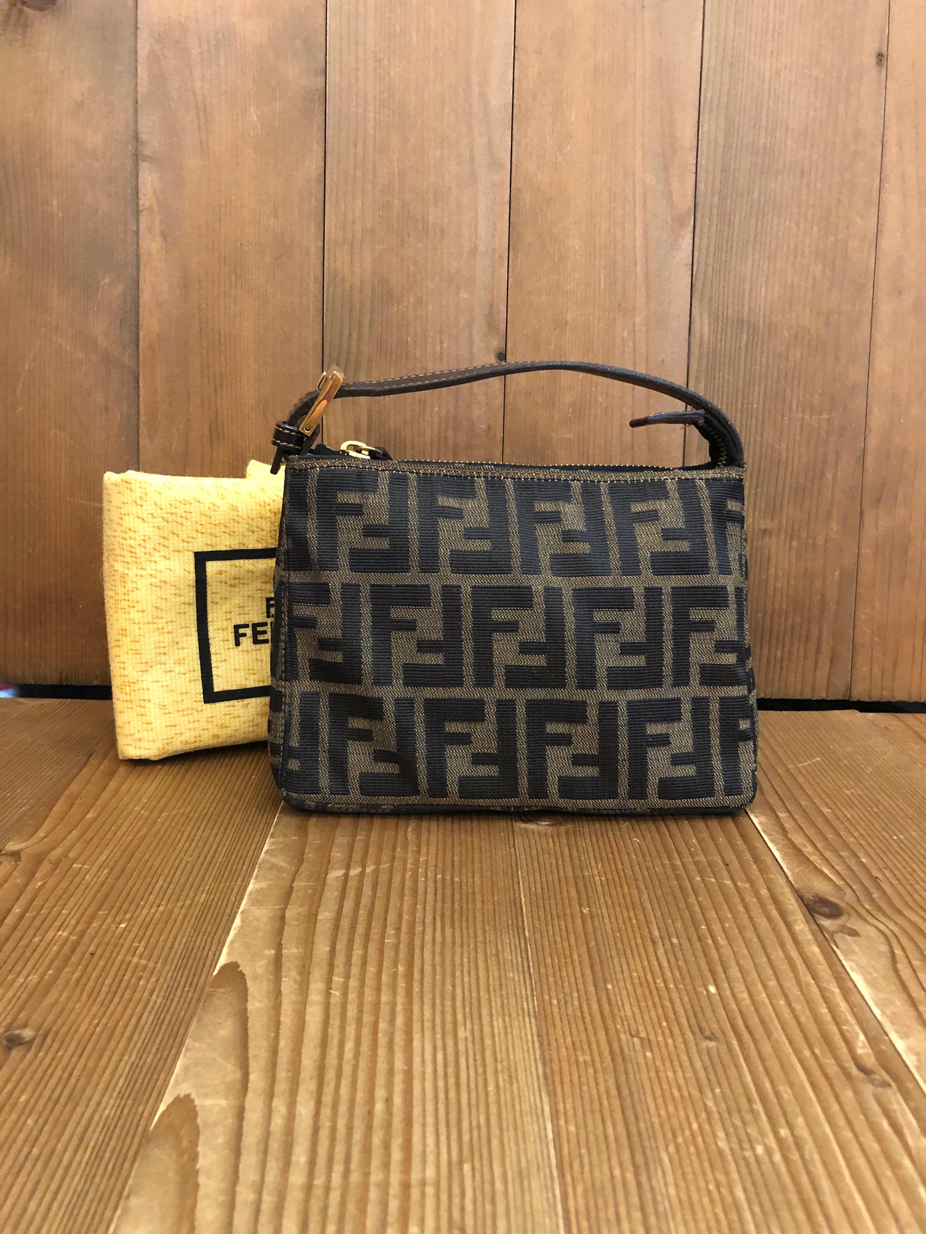 Vintage FENDI mini pouch handbag in Fendi's iconi Zucca jacquard in brown trimmed with brown leather. Zipper top closure opens to a new beige interior. Made in Italy. Measures 7.25 x 5.25 x 3 inches (fits plus-sized iPhone). Comes with dust