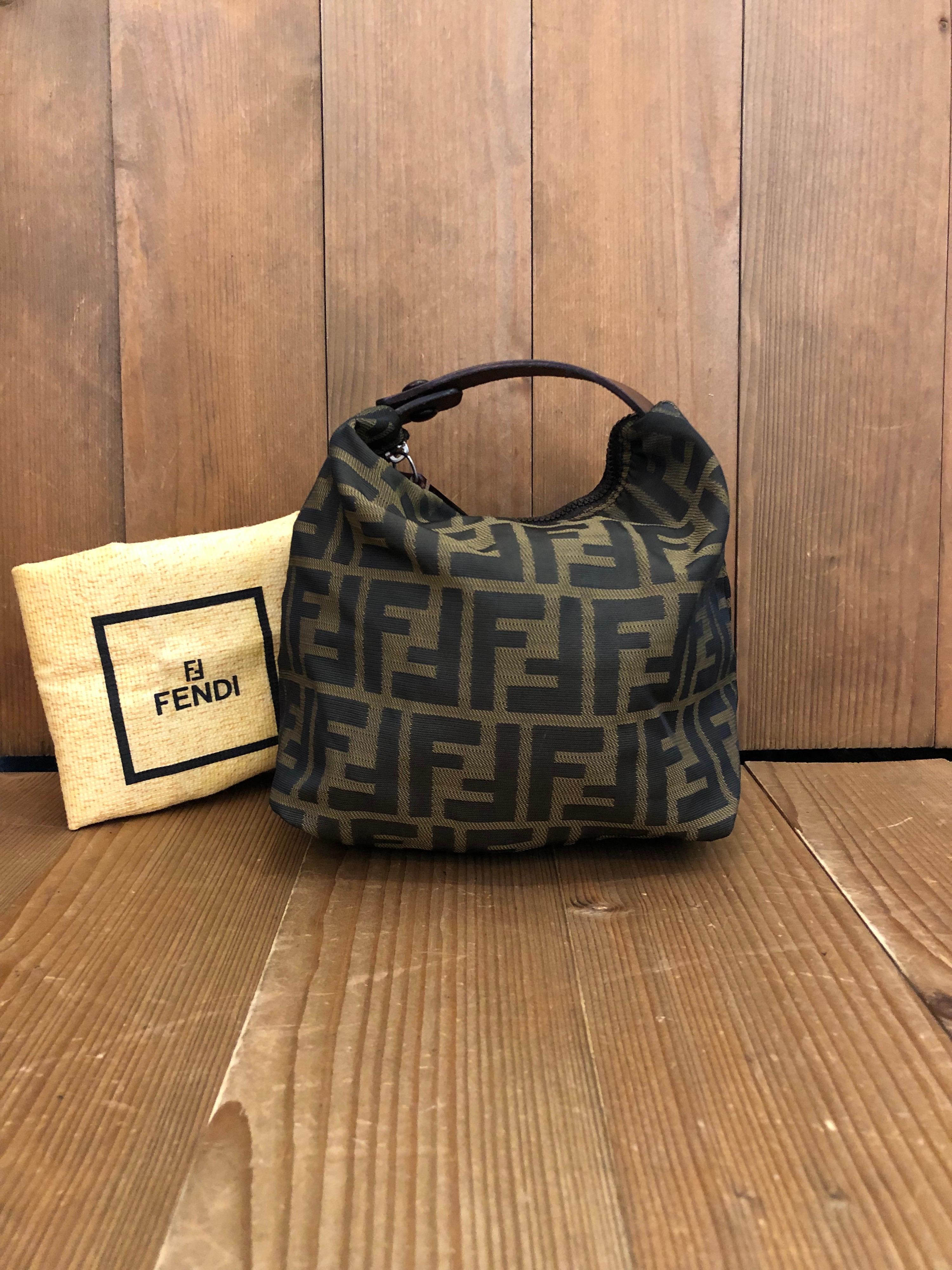 1990s Fendi mini pouch handbag in Fendi's iconic brown Zucca jacquard and leather. Made in Italy. Measures 7 x 6 x 4 inches Handle drop 2 inches. Comes with dust bag.

Condition - Minor signs of wear. Generally in good condition.
