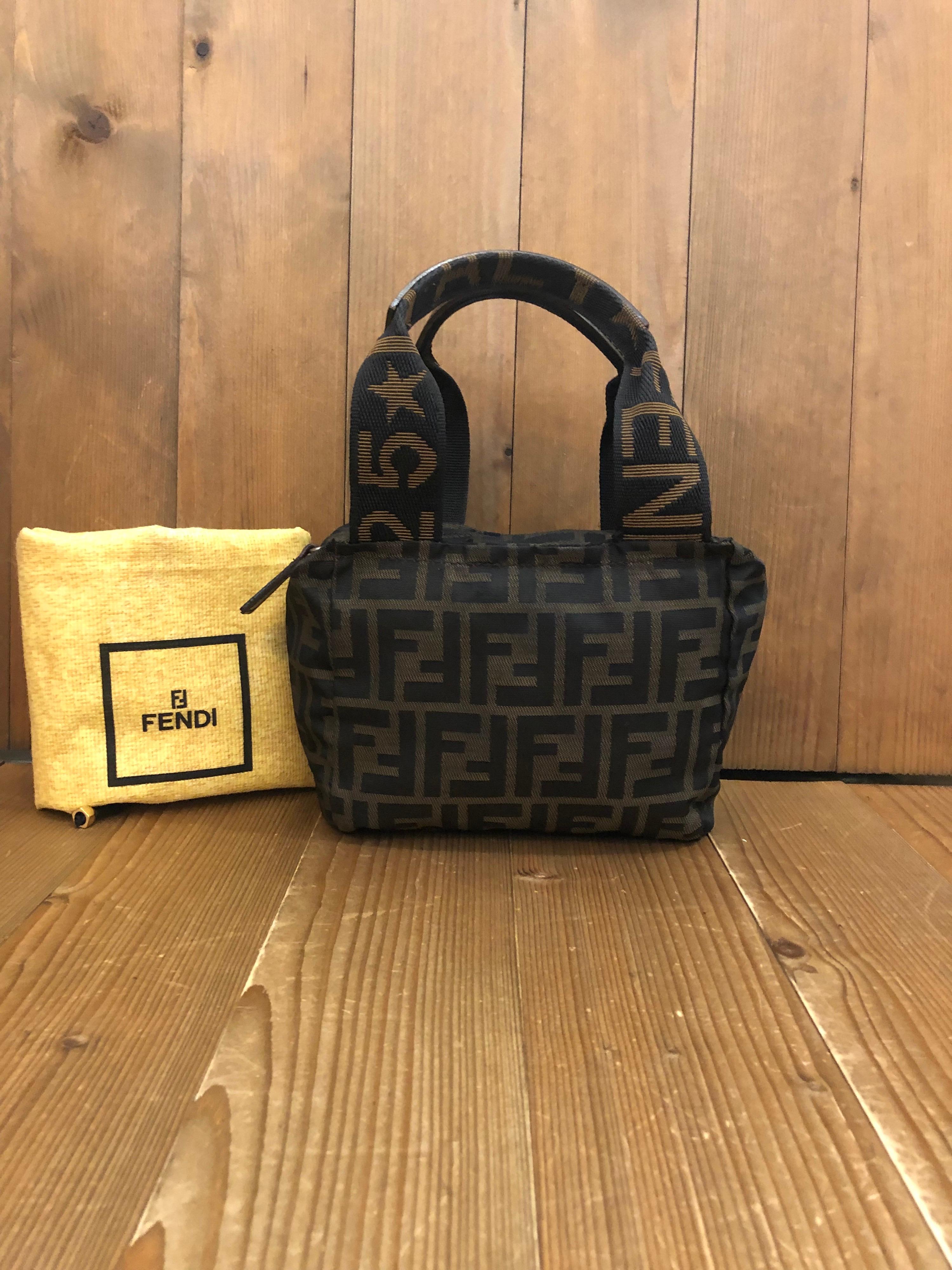 Vintage Fendi mini handbag in Fendi's iconi Zucca  jacquard featuring leather trimmed handles. Made in Italy. Measures 7 x 5.75 x 3.5 inches Handle Drop 4 inches (fits plus-sized iPhone)

Condition: Minor signs of wear. Generally in good