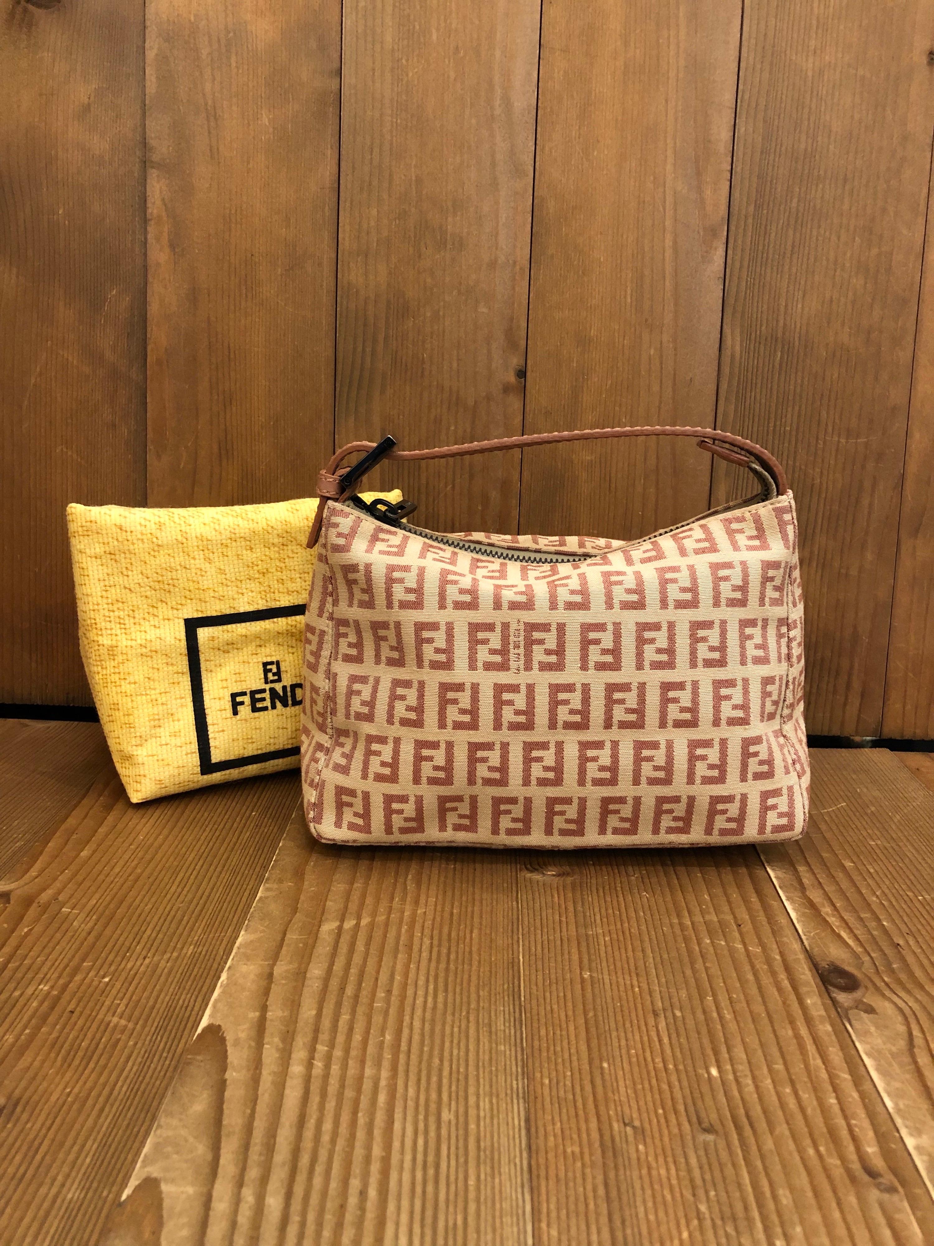 1990s Fendi mini pouch handbag in pink/beige Zucchino jacquard. Zipper top closure. Made in Italy. Measures 7.5 x 5 x 3.25 inches (fits plus-sized iPhone). Come with dust bag. 

Condition: Some signs of wear on lining consistent with age. Exterior