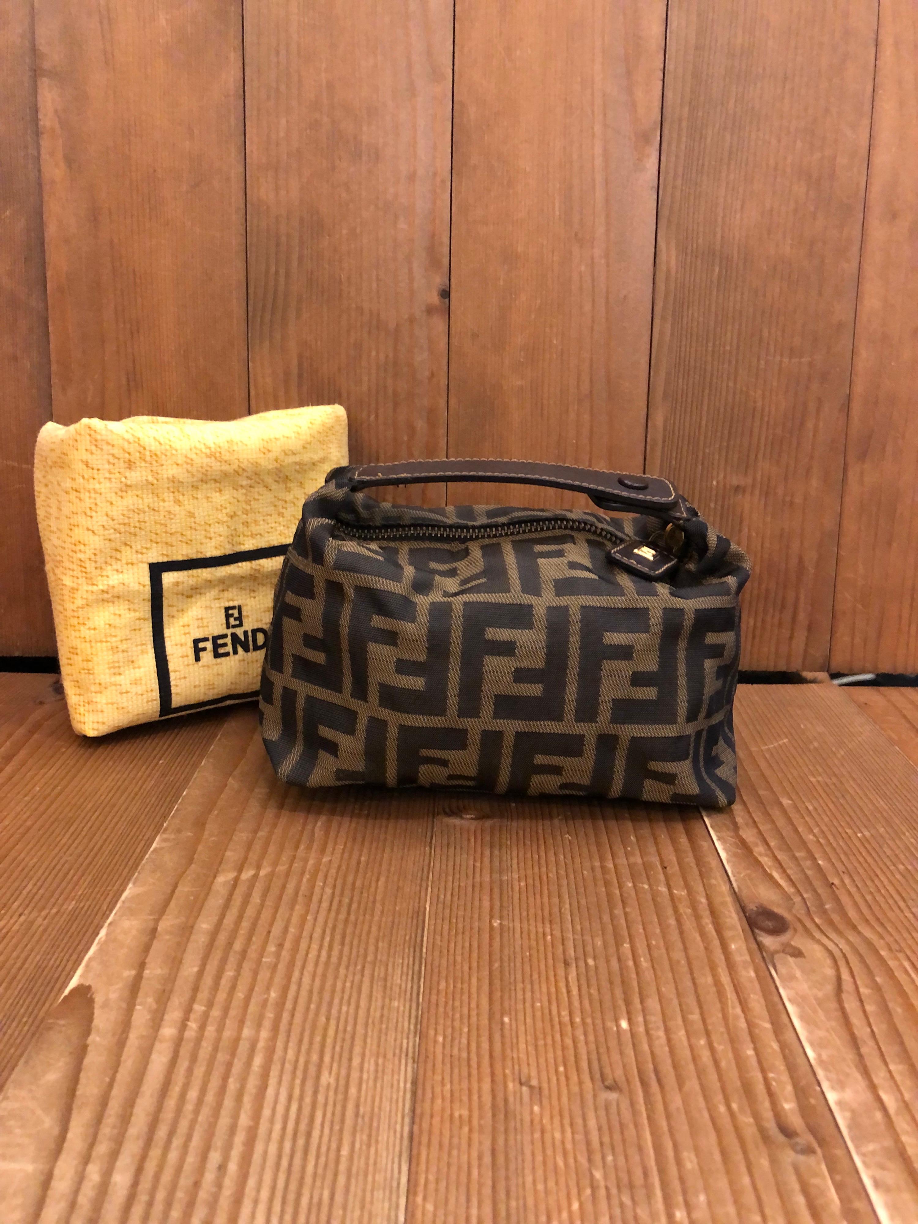 Vintage Fendi mini pouch handbag in Fendi's iconic brown Zucca jacquard. Zipper top closure. Made in Italy. Measures 6.5 x 4 x 4 inches (fits plus-sized iPhone). Comes with dustbag.

Condition: Minor signs of wear. Generally in very good condition