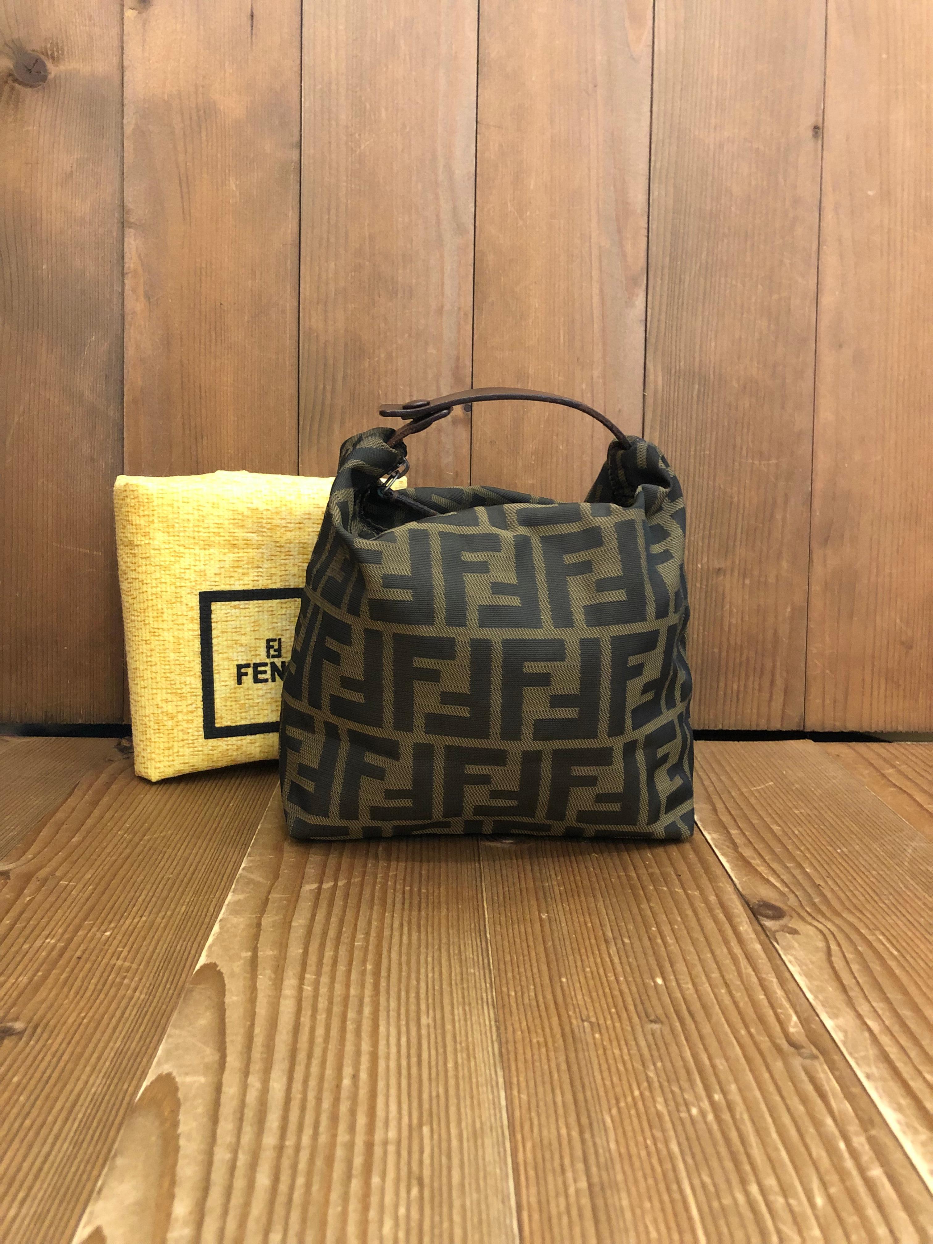 Vintage Fendi mini pouch handbag in Fendi's iconic brown Zucca jacquard. Zipper top and snap closure open to an un-lined interior. Made in Italy. Measures approximately 6.5 x 6.5 x 4.25 inches (fits plus-sized iPhone). Comes with